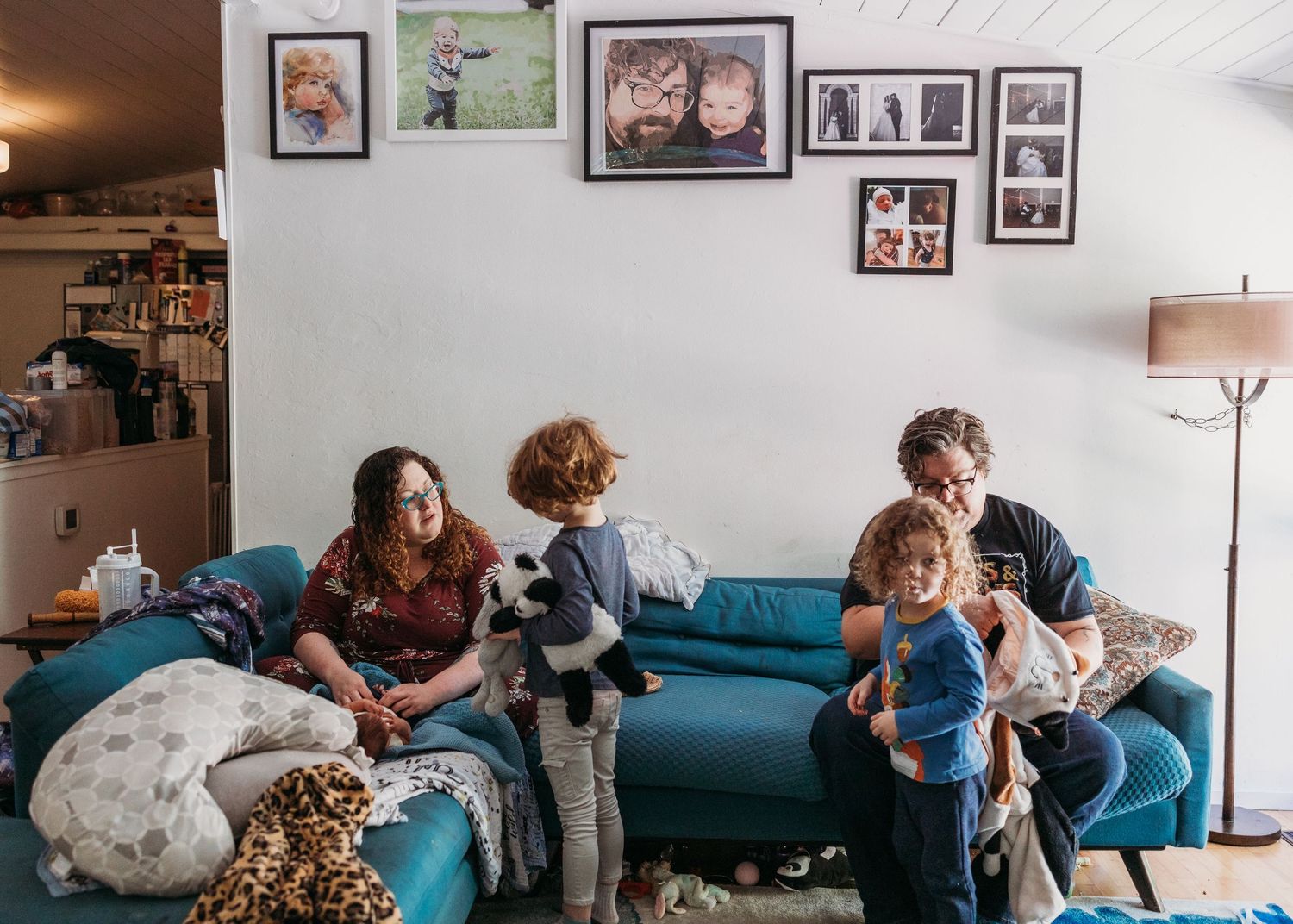 A panoramic sequence showing people playing and interacting on a blue couch in a living room with framed photos on the wall.