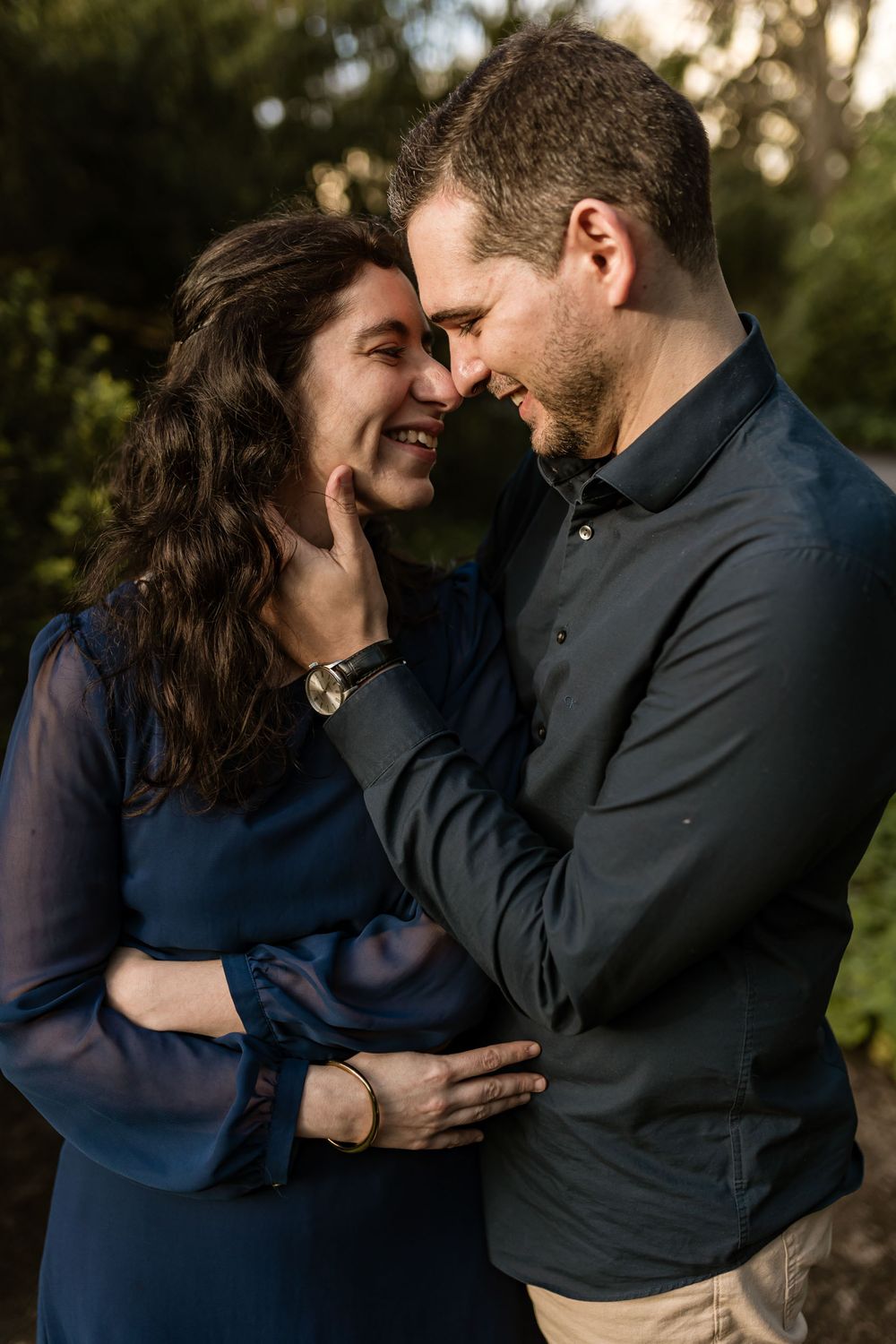 Close up romantic portrait of couple touching foreheads during golden hour photoshoot in Lisbon