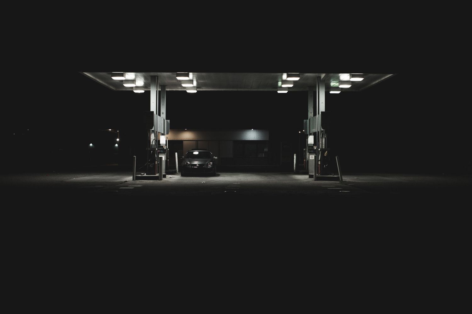 Cinematic nighttime automotive photography with dramatic lighting and modern commercial style.