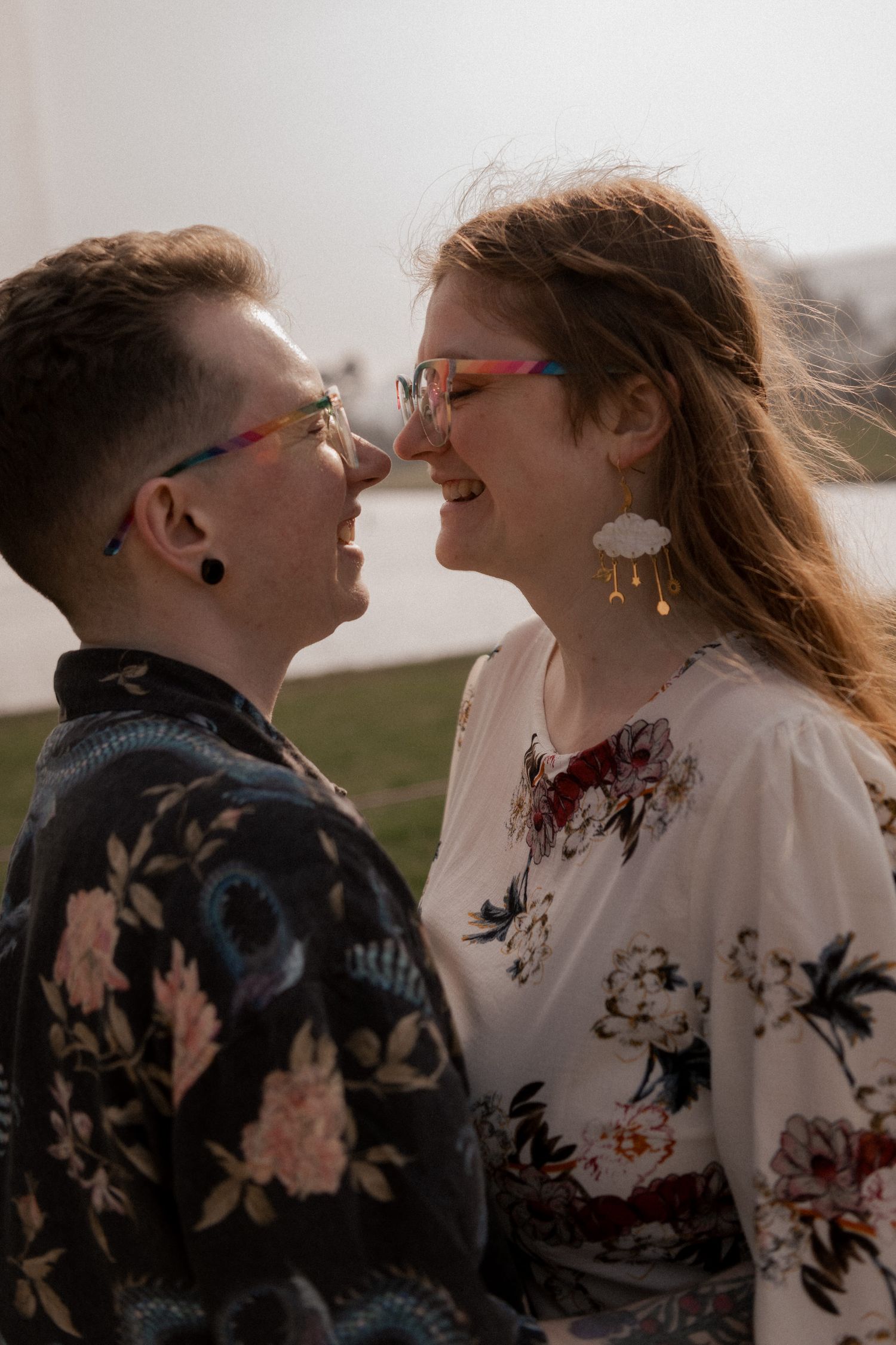 A couple in matching floral outfits share intimate moments in a series of romantic outdoor portraits at sunset.