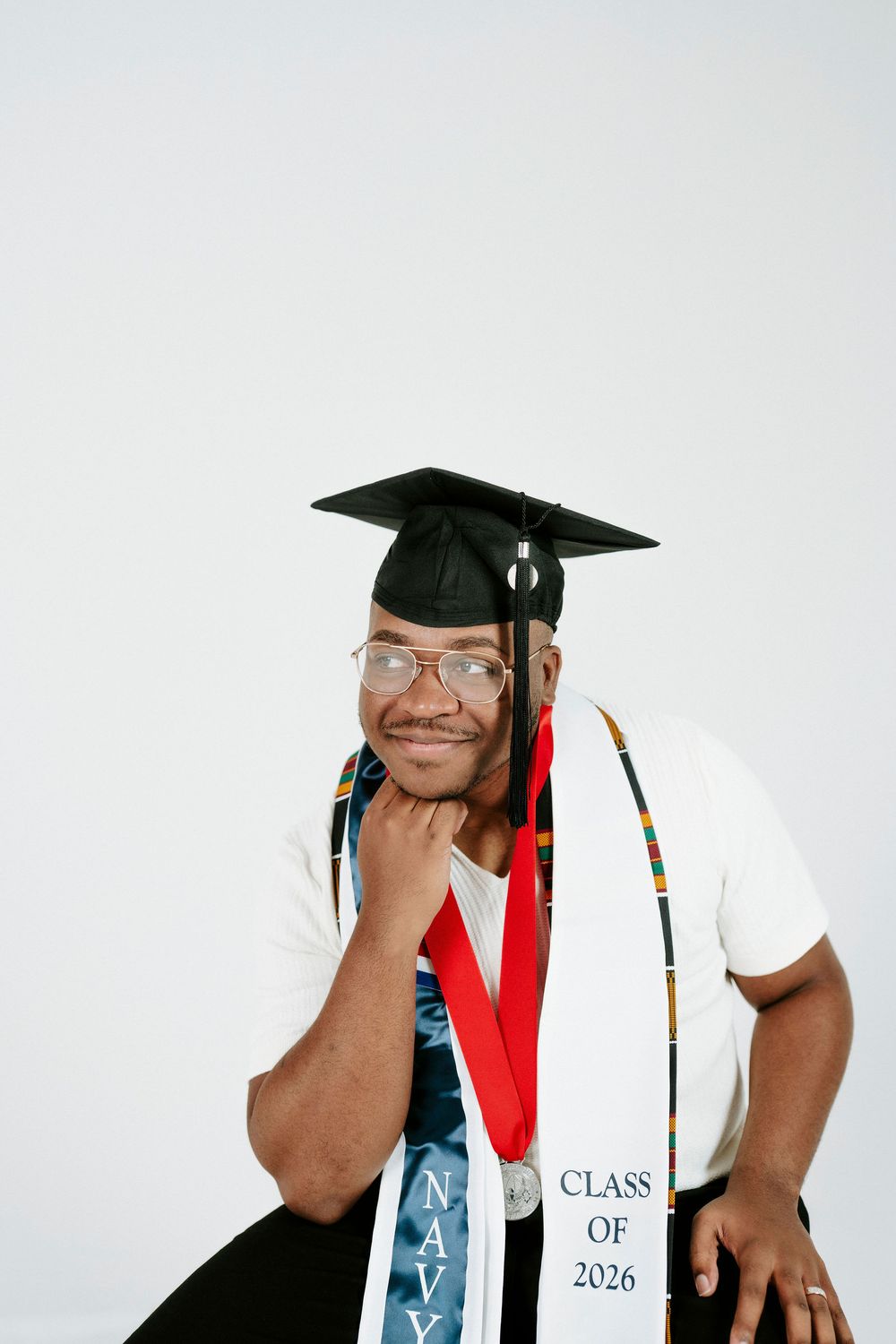 A graduation photo series showing a person in cap and gown with a diploma against a light background.