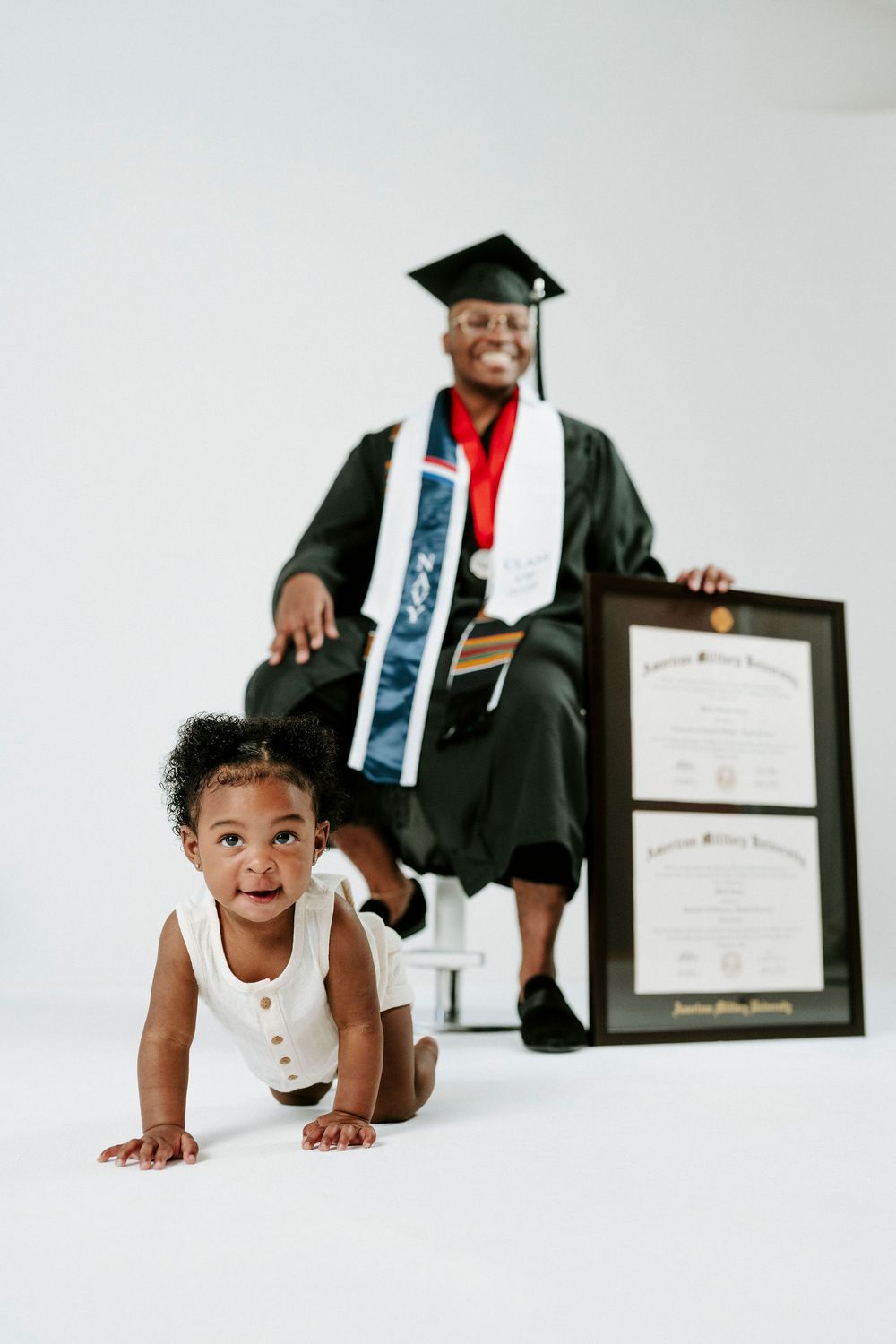 A series of graduation photos showing a graduate in cap and gown posing playfully on the floor with diplomas.