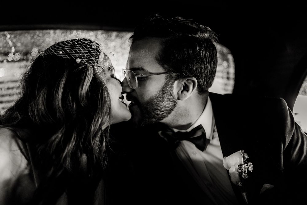 Silhouettes of a couple in a romantic embrace against a dark background.