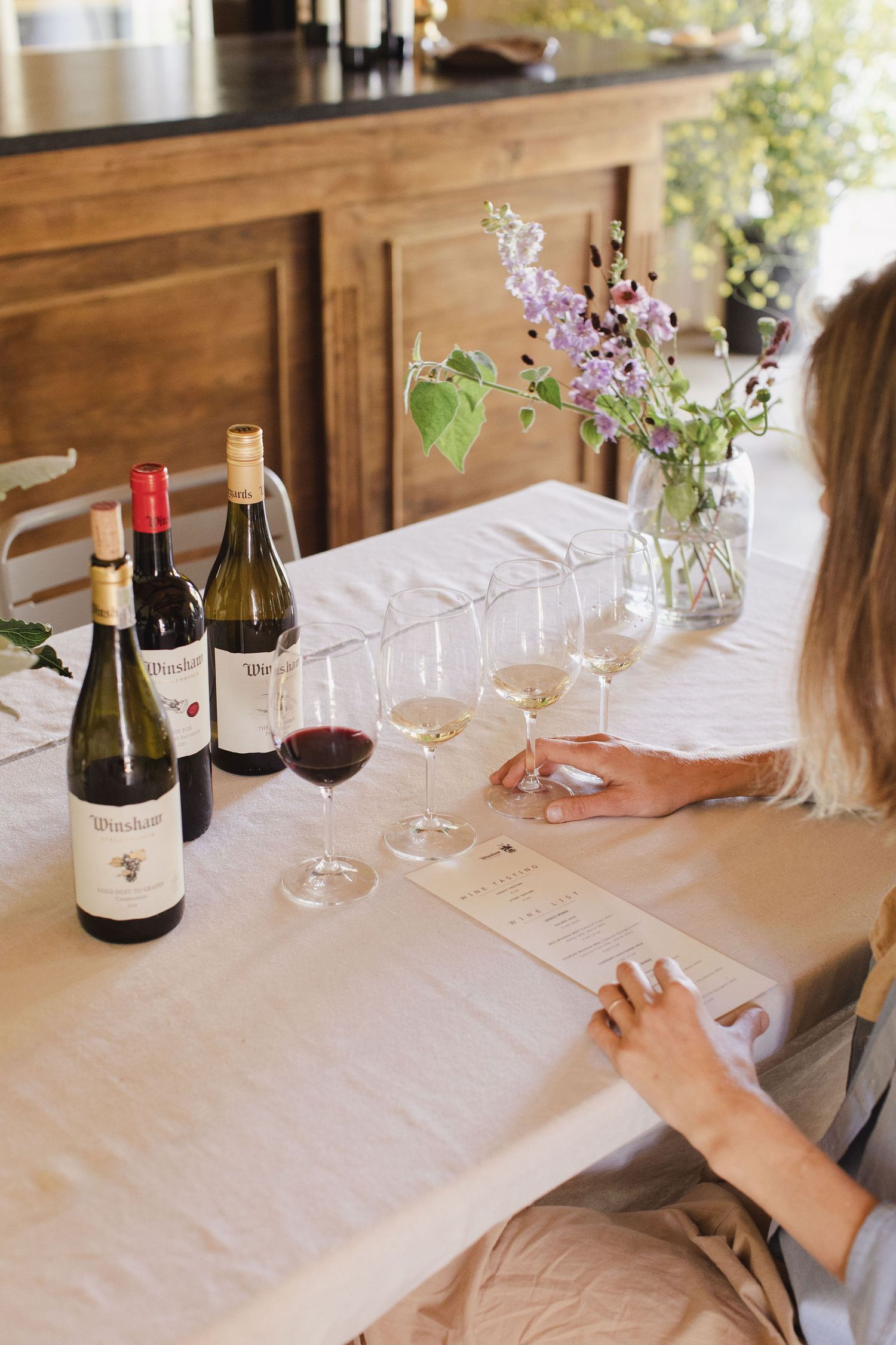 Rustic vineyard table decor with natural textures and wine bottles
