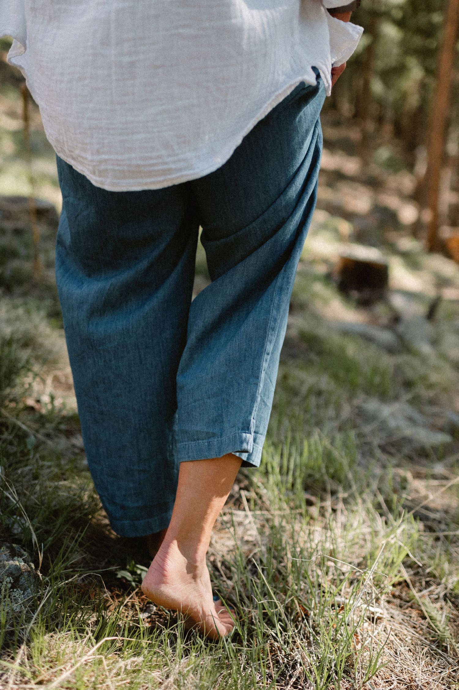 Colorado photographer walking barefoot in yard in natural light, spring lifestyle branding image