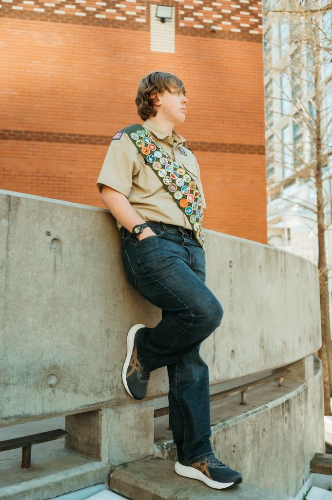A series of four sequential photos showing someone climbing up a concrete wall in an urban setting.