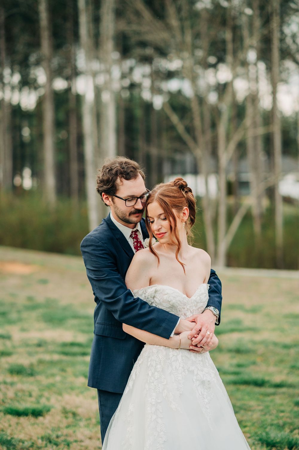 Romantic outdoor wedding portrait in a rustic wooded setting.