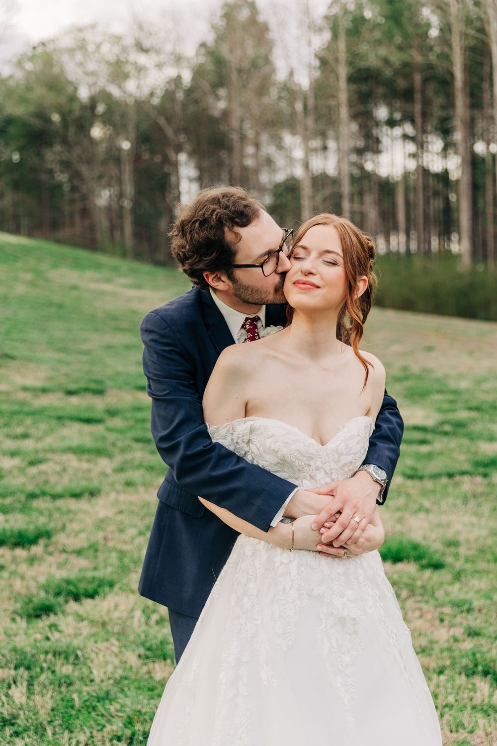Romantic couple portraits in a grassy field with flowing white wedding dress.