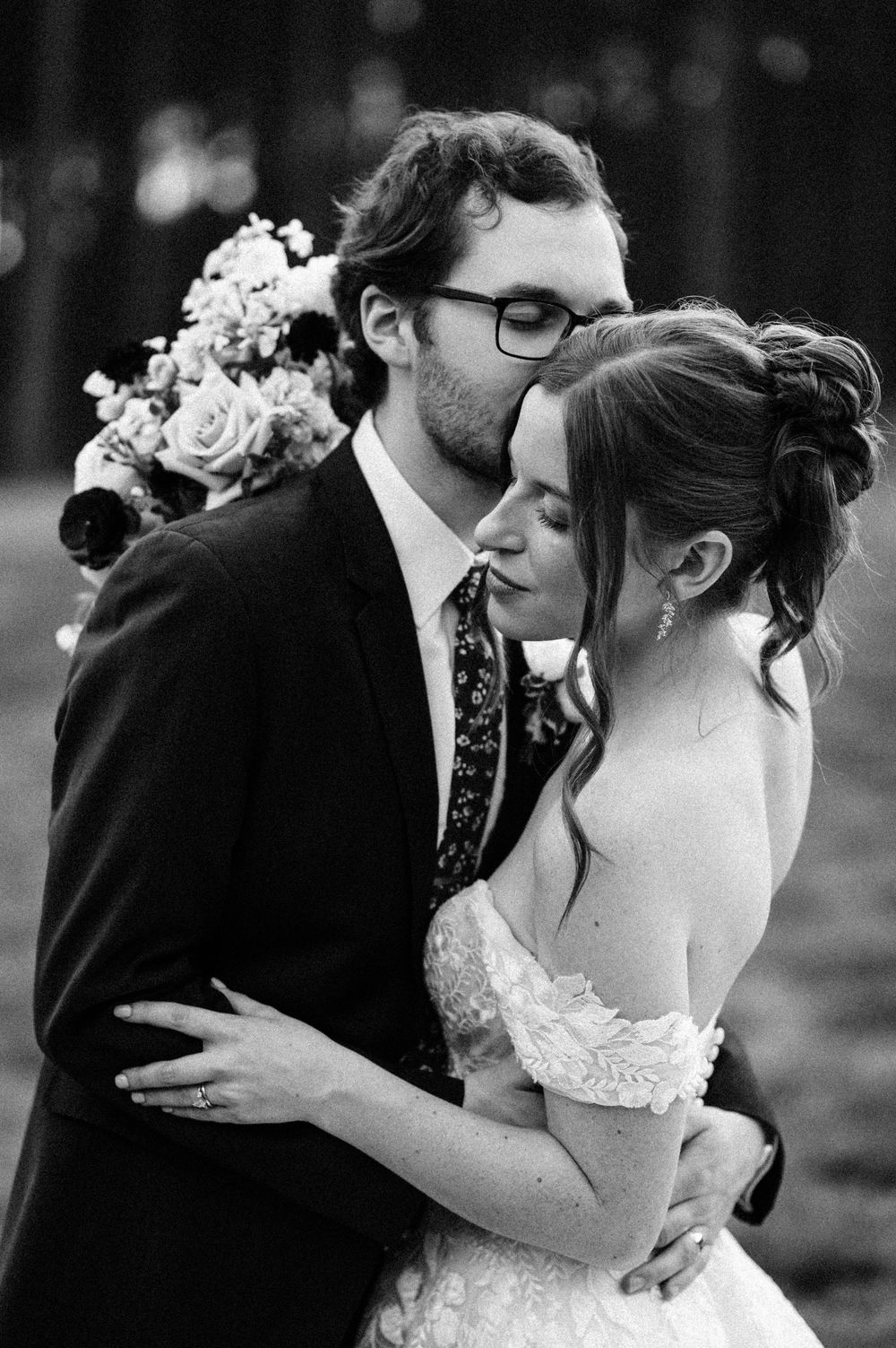 Black and white romantic wedding portraits showing tender moments between newlyweds.