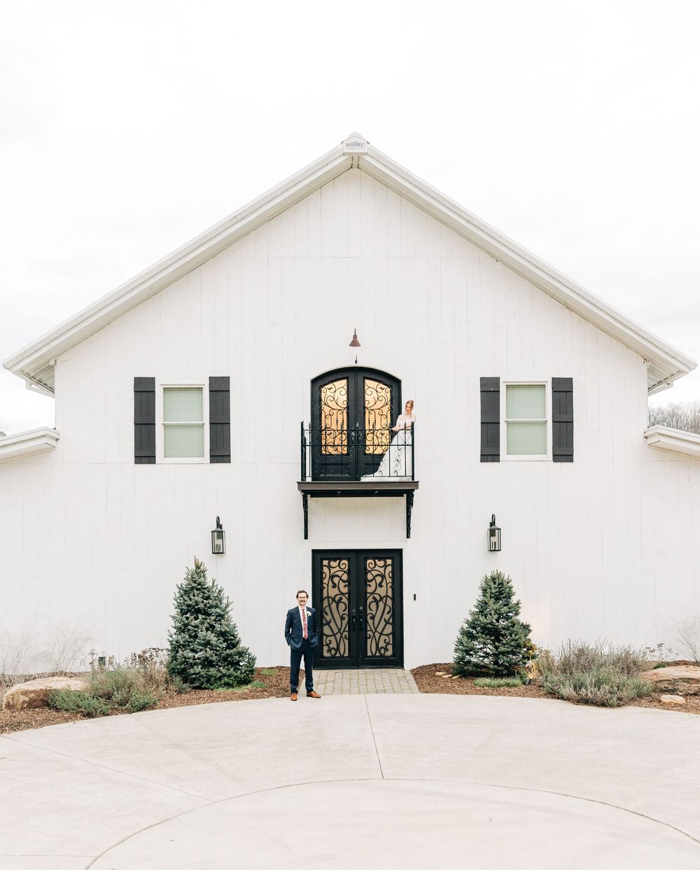 A modern white chapel with black accents and glass doors is shown from four different angles in a collage.