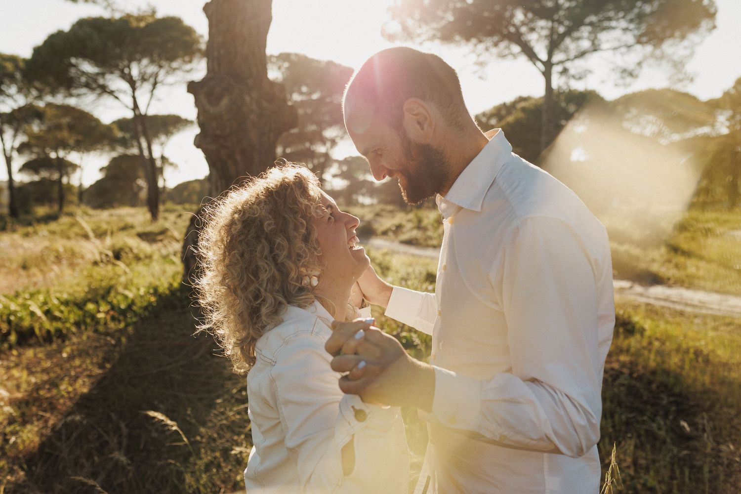 Blurred foreground couple with dog walking on path during natural engagement session Portugal