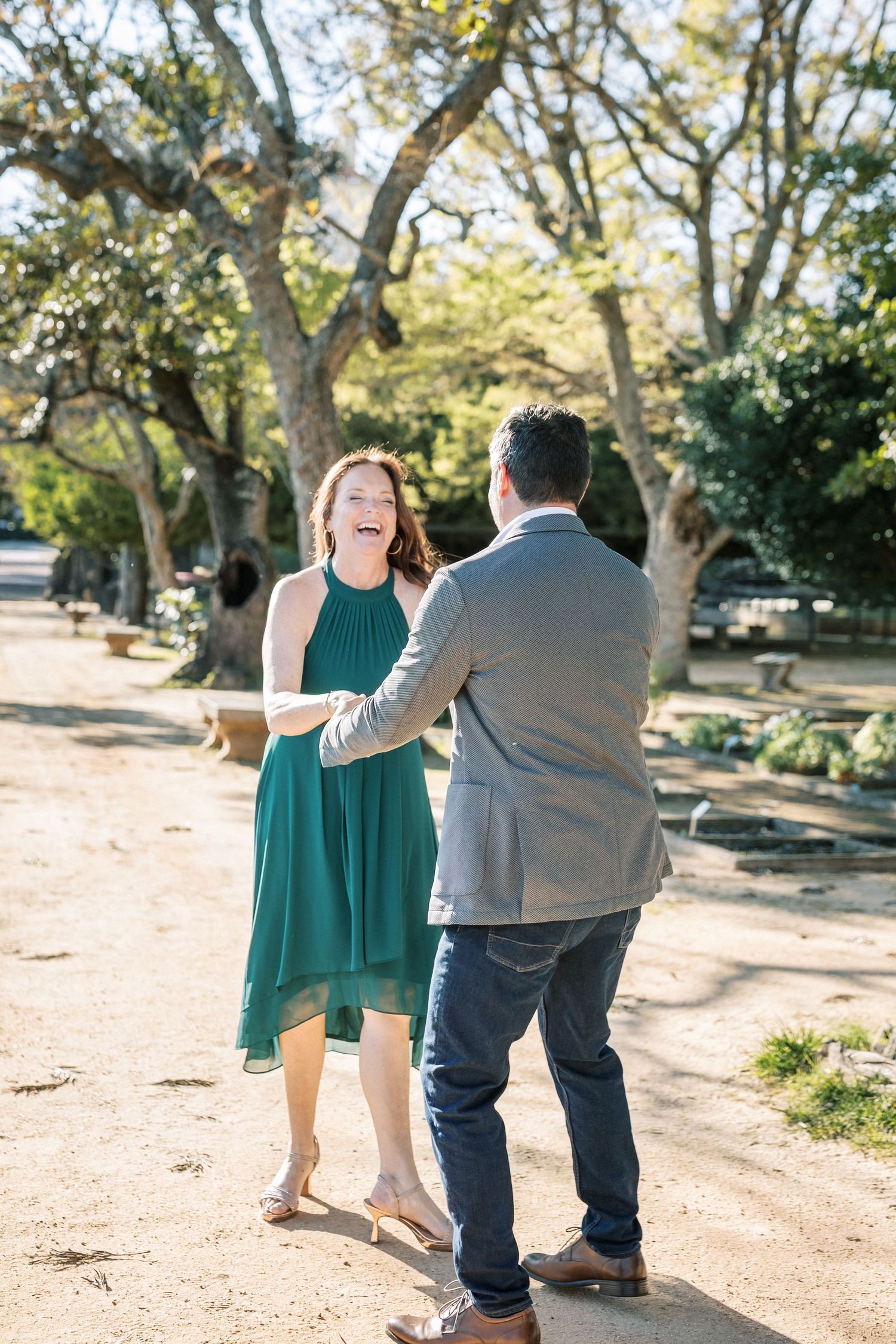 Couple laughing during engagement session in Lisbon garden