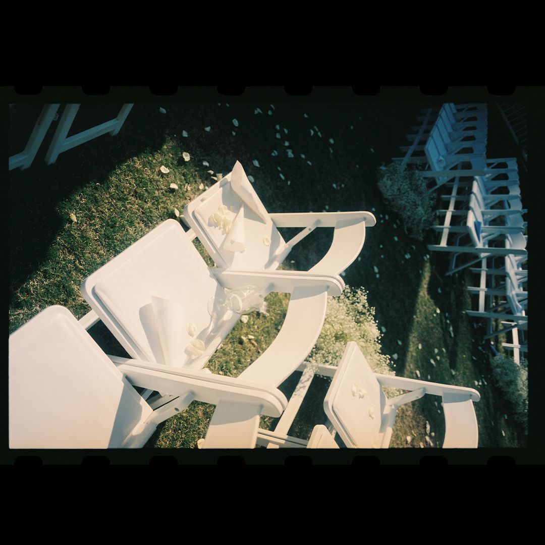 Architectural model made of white paper or cardboard showing abstract geometric shapes and levels against a dark background.