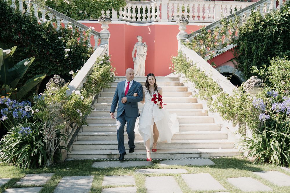 Bride and father walk down the steps of Villa Casa Rossa in Imperia before the ceremony