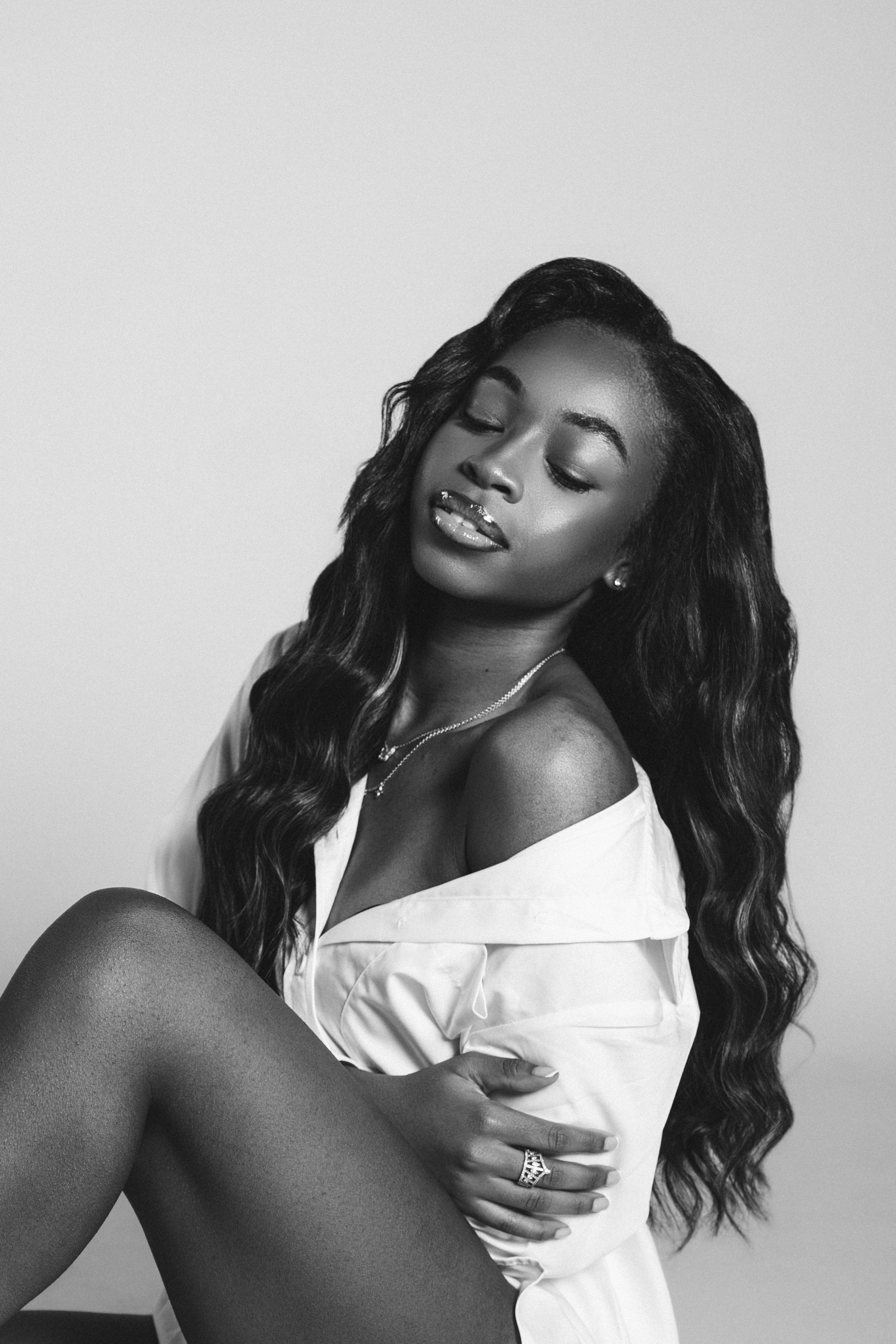 Black and white fashion portraits showing artistic poses in white clothing against light background.