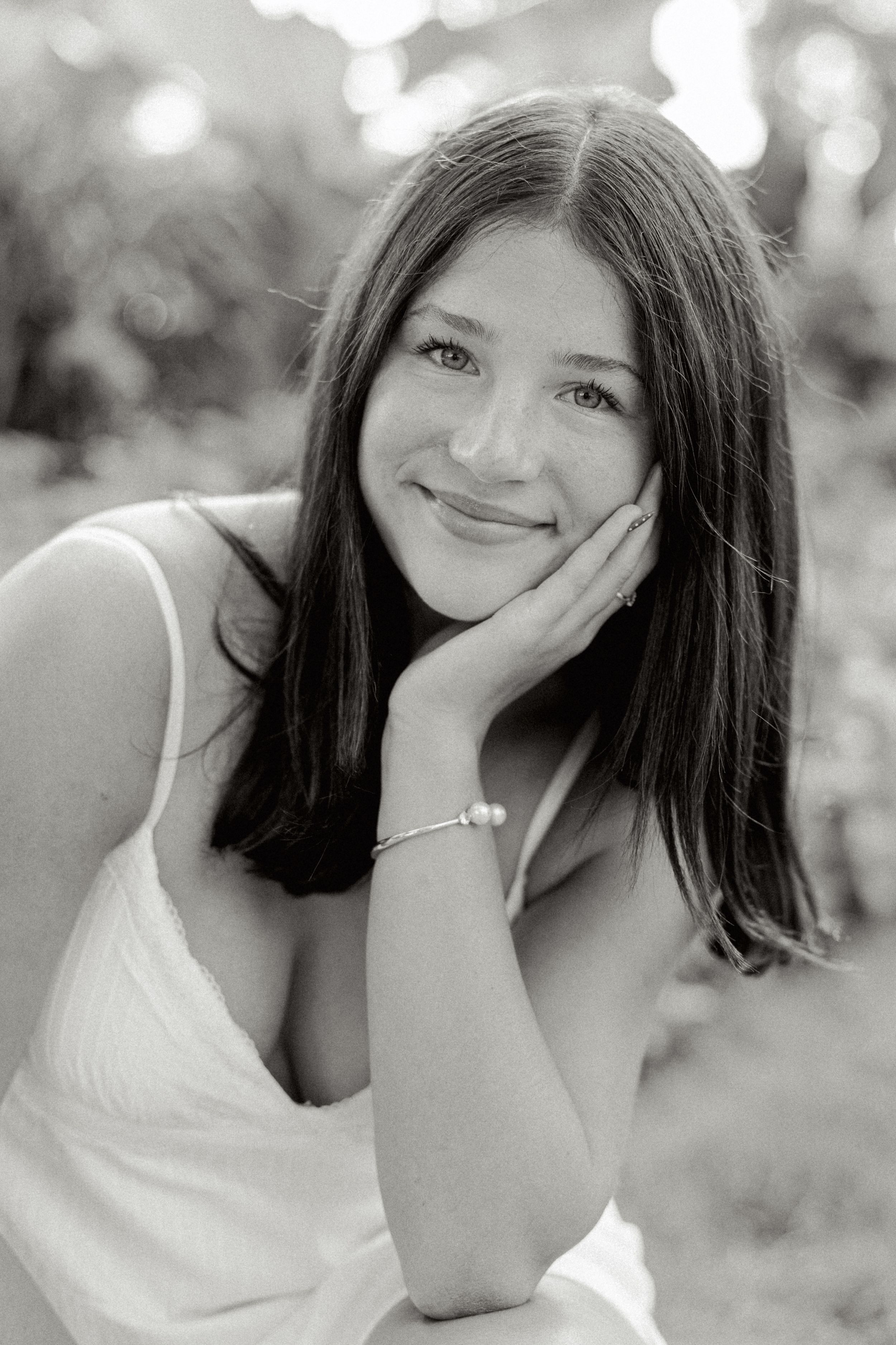 Black and white portrait series showing joyful expressions against a soft bokeh background.
