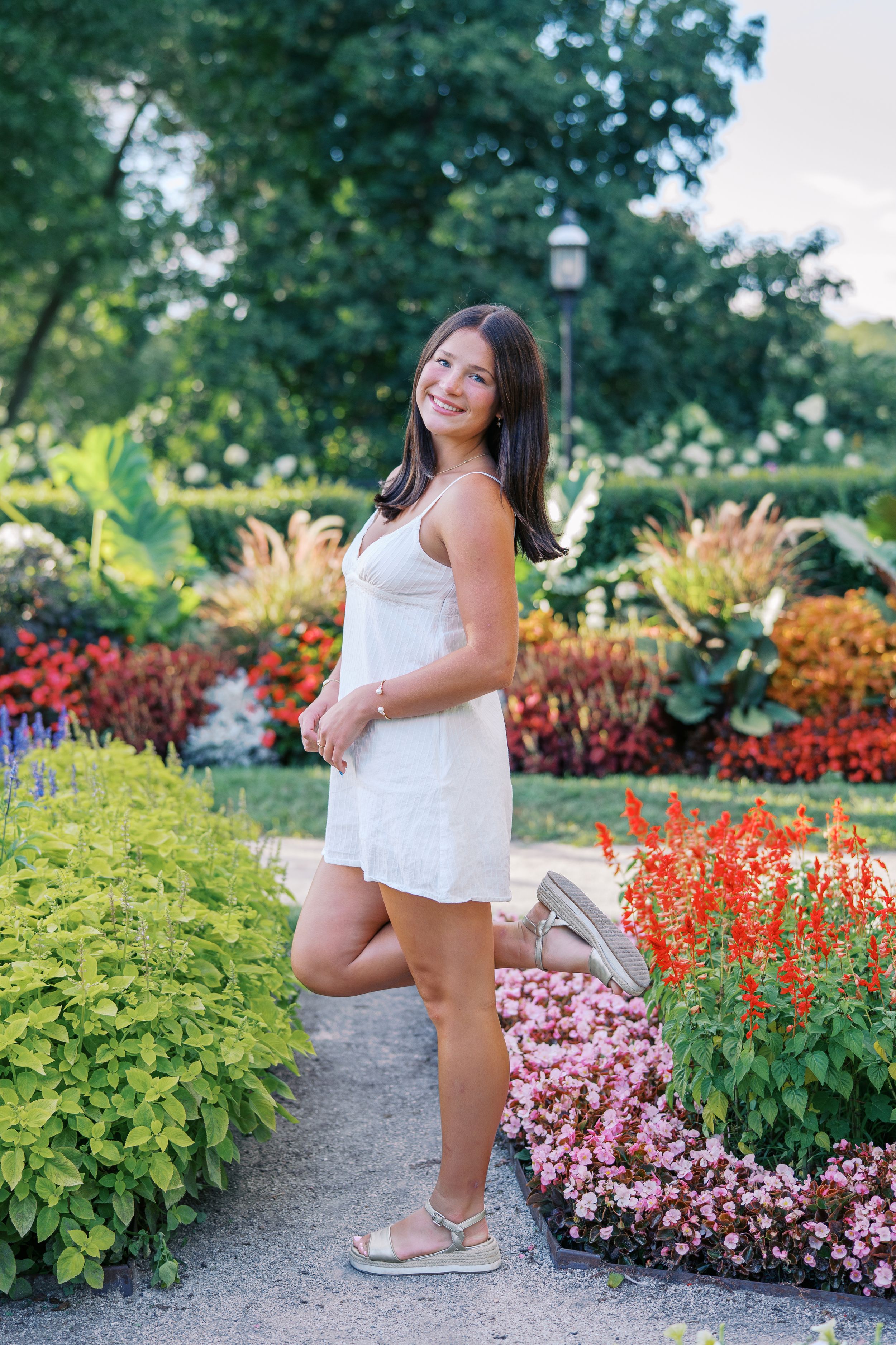 A series of outdoor photos in a vibrant garden with colorful flowers and greenery along a walking path.