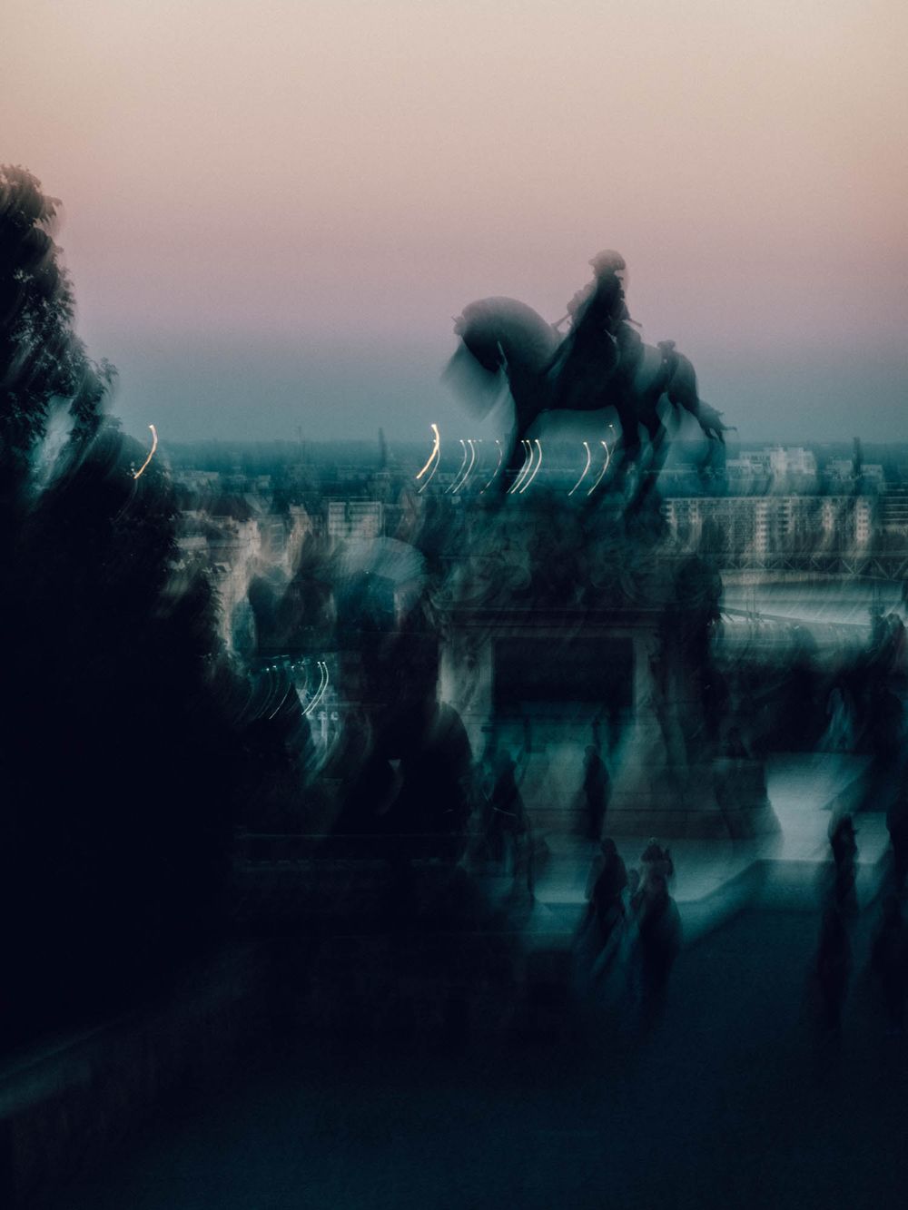 Blurred equestrian statue silhouette against dusky pink sky with ghostly figures and light streaks.