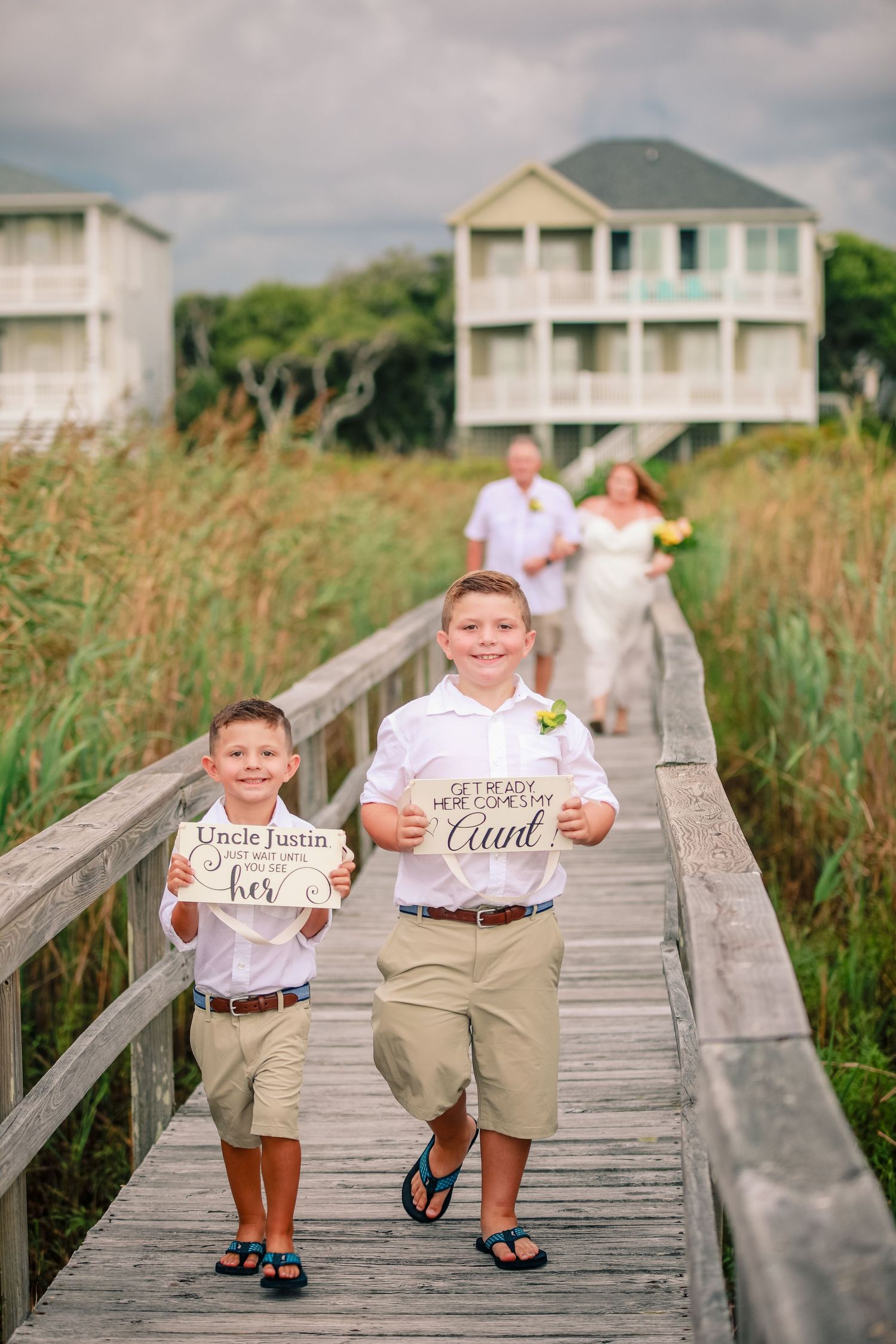 Small beach wedding, kids holding here comes the bride signs, Captured by Tasha Cannaday, Essex-County.