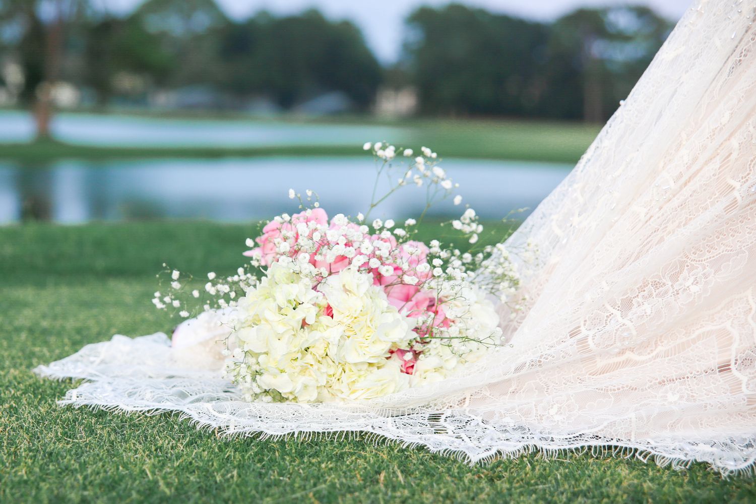wedding dress and flower bouquet chapter in a photo outdoors on the water, Windsor Ontario.