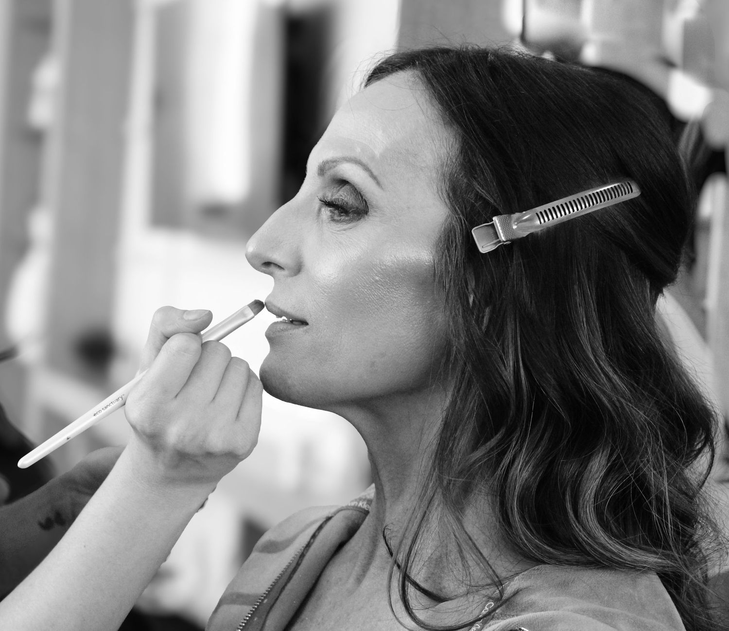Close-up profile shots of makeup application with cosmetic brushes and tools.