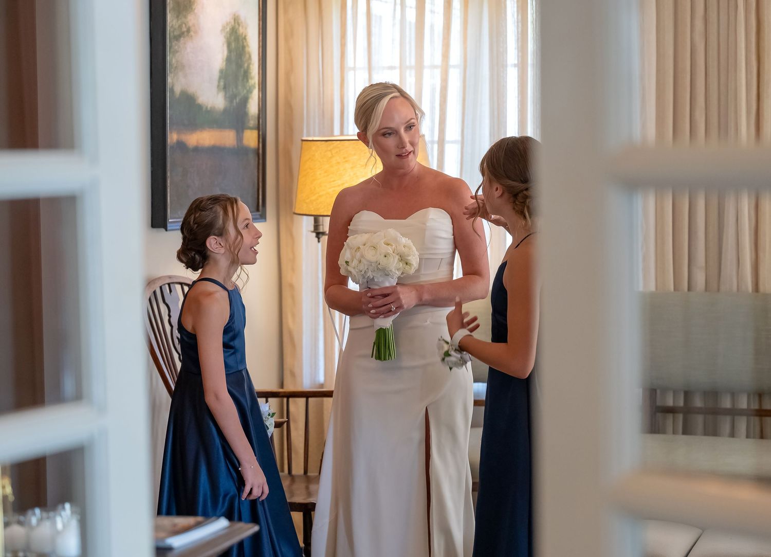 Gorgeous bride with her future step-daughters, romantically photographed through French-doors in Skaneateles, New York, CNY Photography.