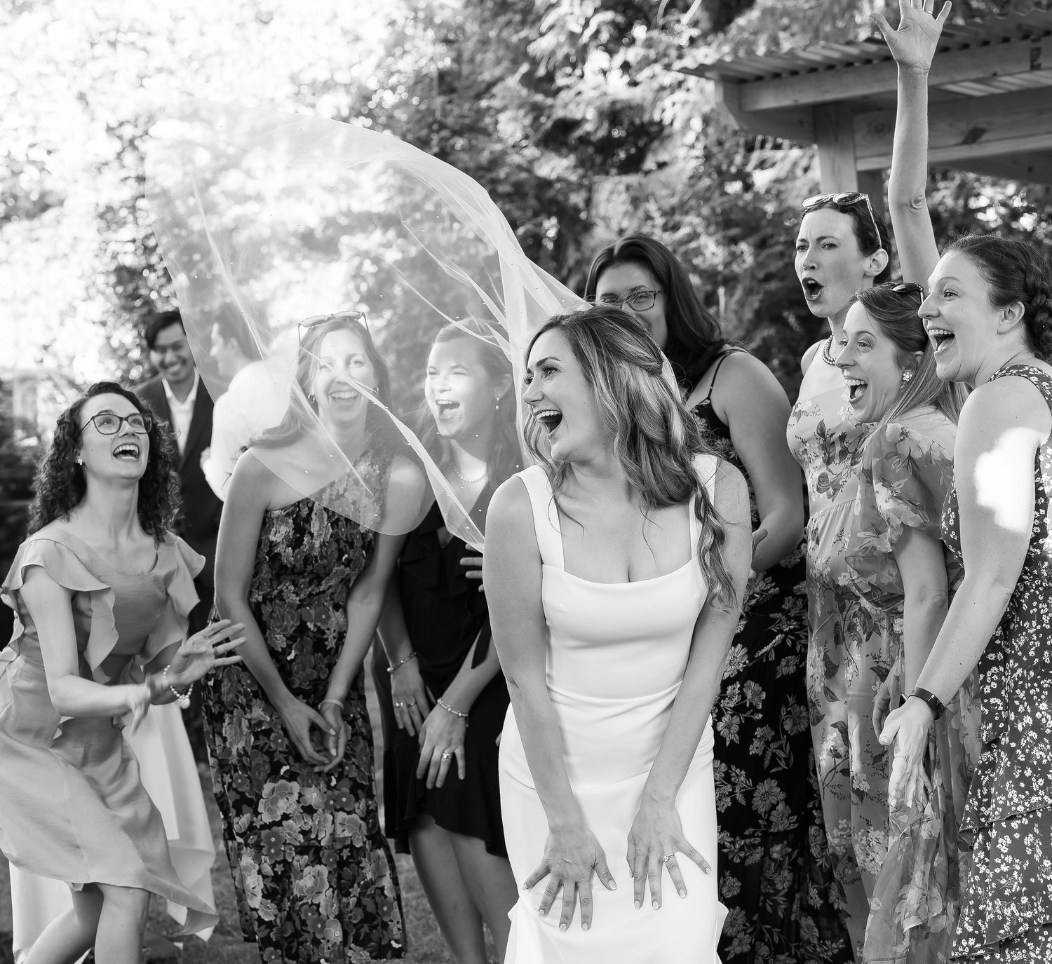 Melissa laughs with joy as her friends billow her bridal veil from behind at the Sherwood Inn in Skaneateles, Summer 2024.