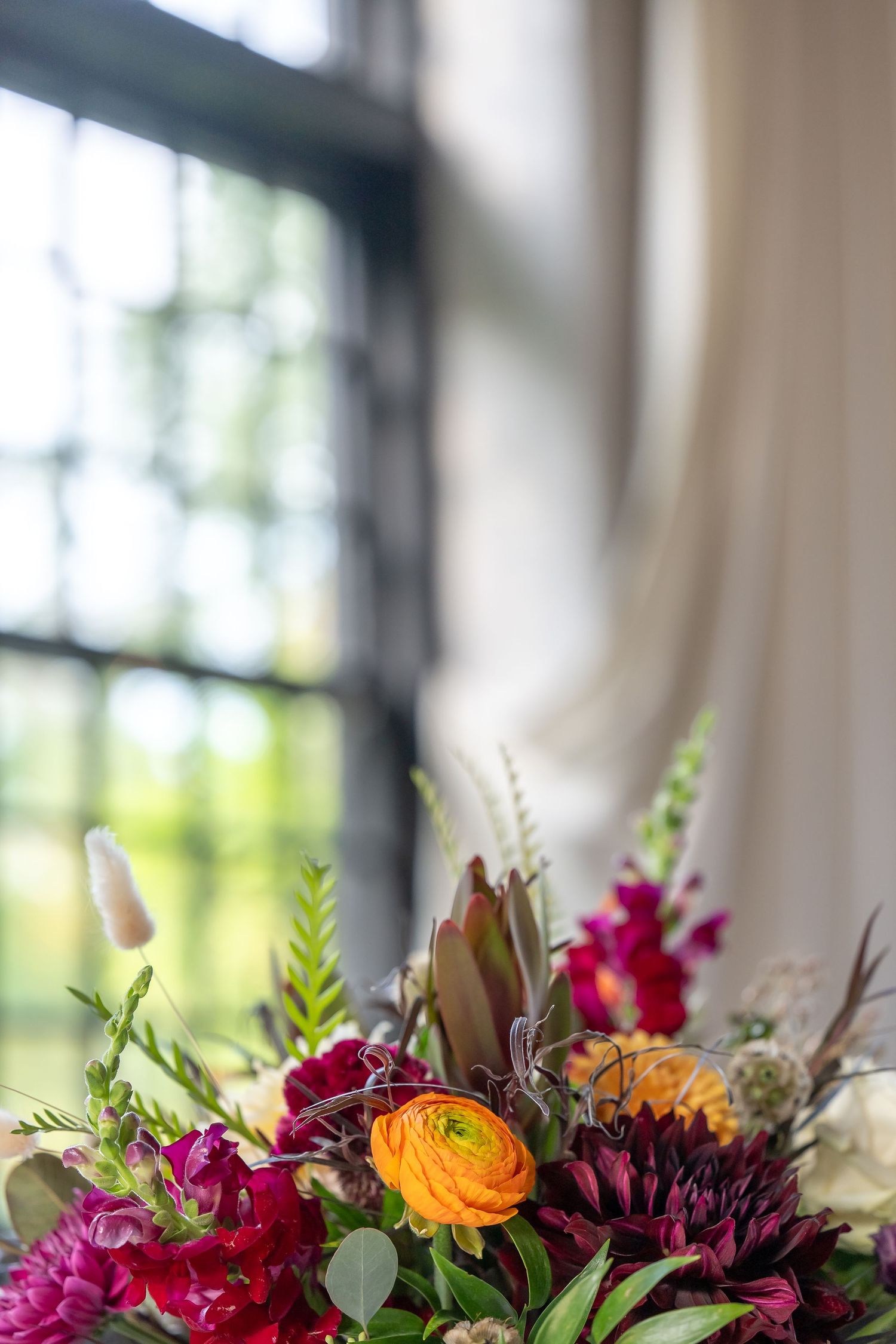Formal wedding reception table decor featuring a flower and wine glass at The Sinclair in Skaneateles, NY, 2024 by CNY Photography.
