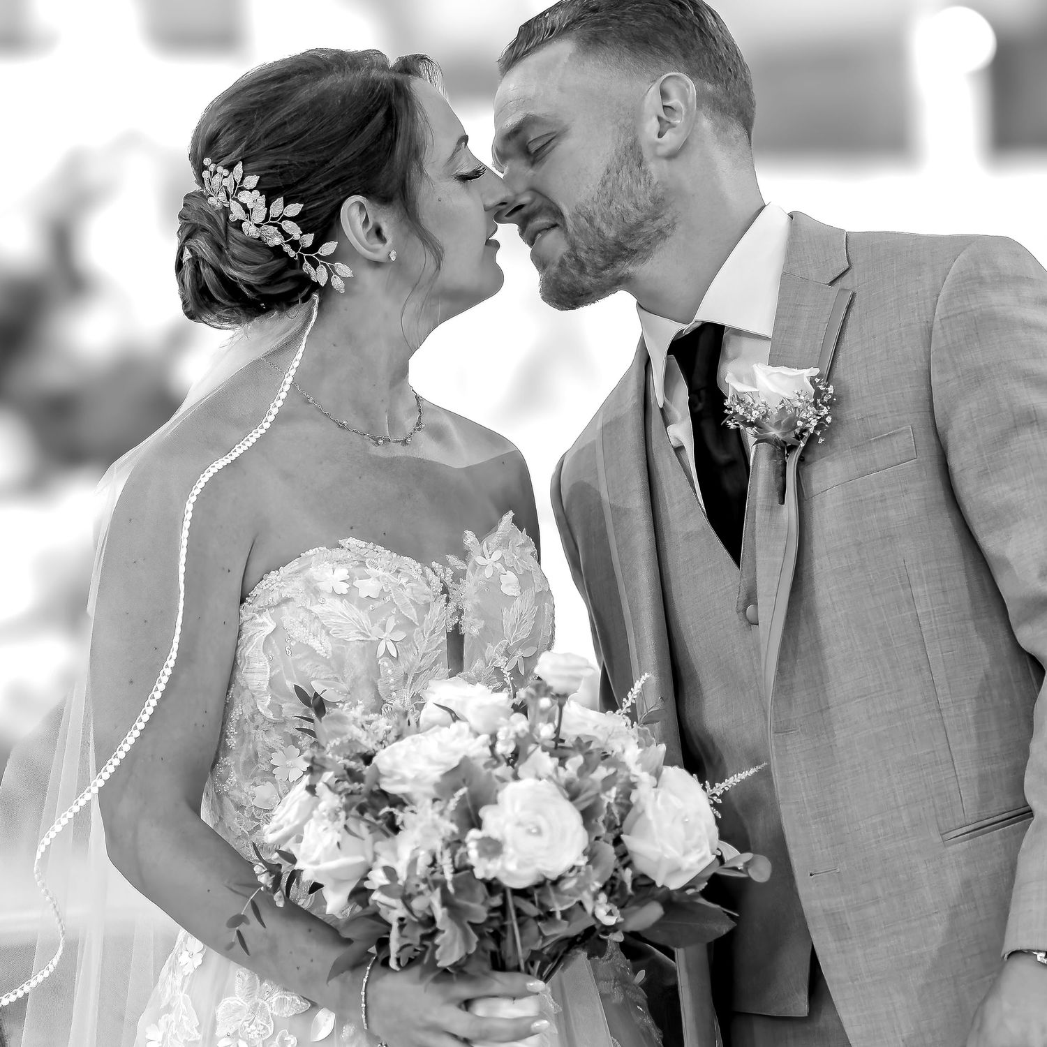 The first kiss, groom kissing bride after wedding ceremony at St James Church in Utica, NY