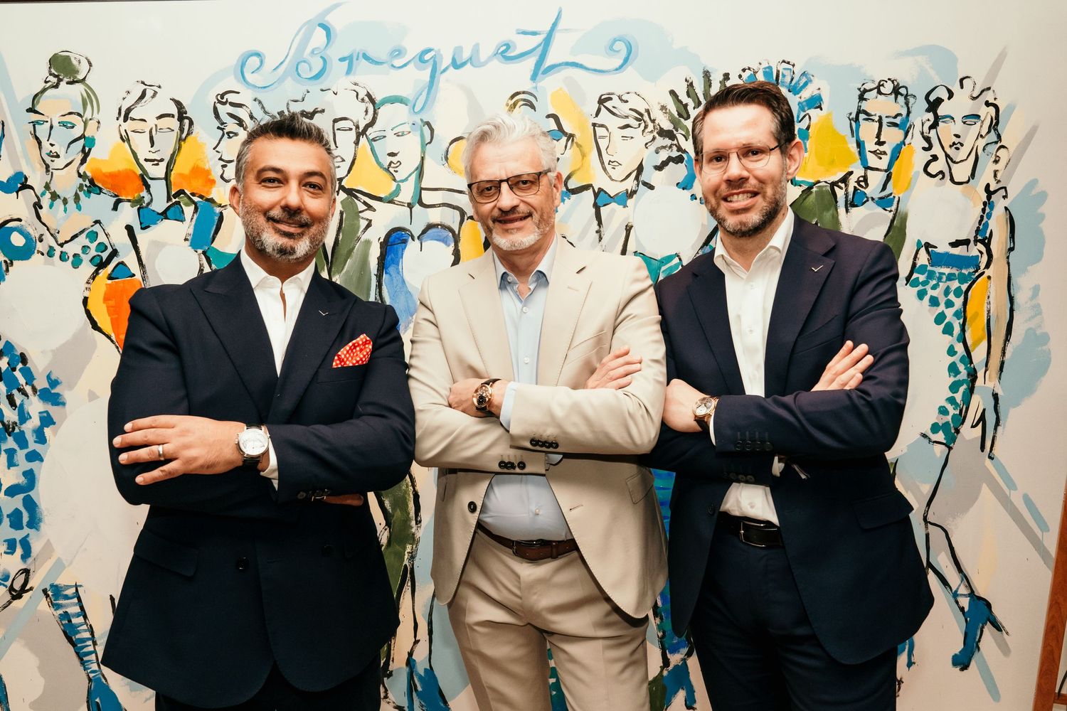 Three businessmen posing against wall with artistic blue sketch mural background.