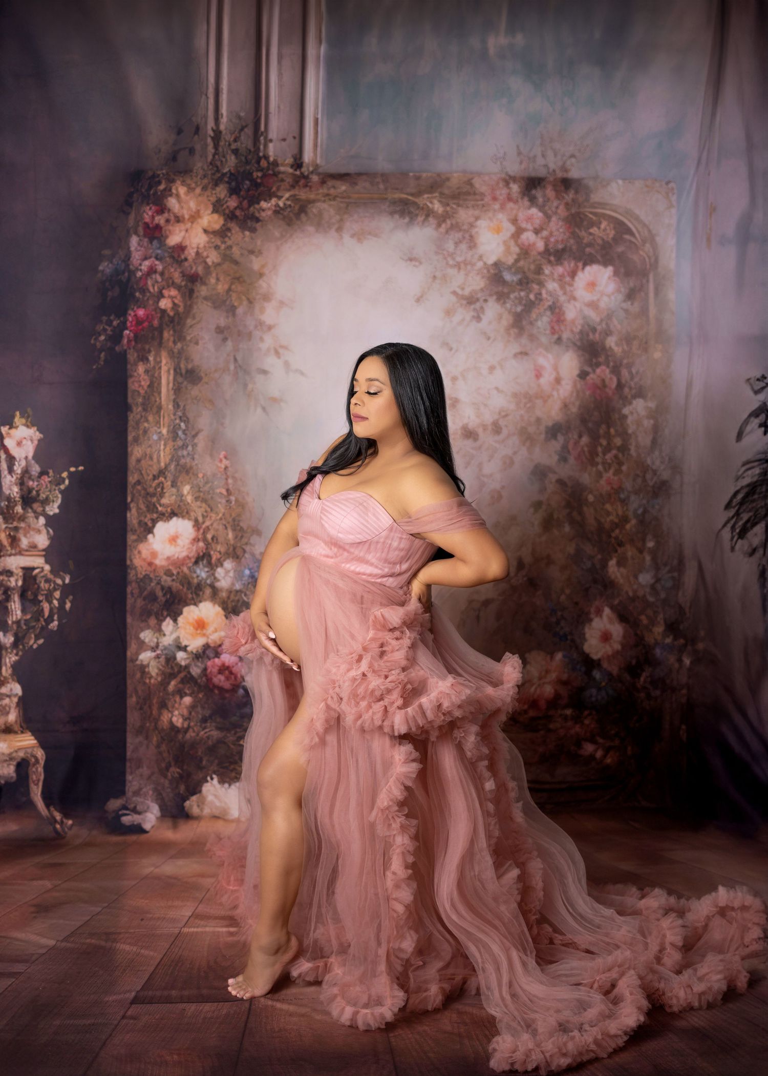 Luxury maternity photography Covina CA with styled gown, soft lighting, and floral backdrop – Ester Nguyen Photography studio
