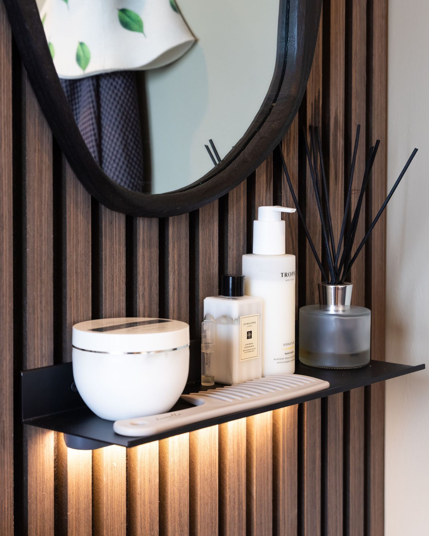 Spa bathroom detail in Bedfordshire with skincare, diffuser and LED lighting, photographed during interior shoot.