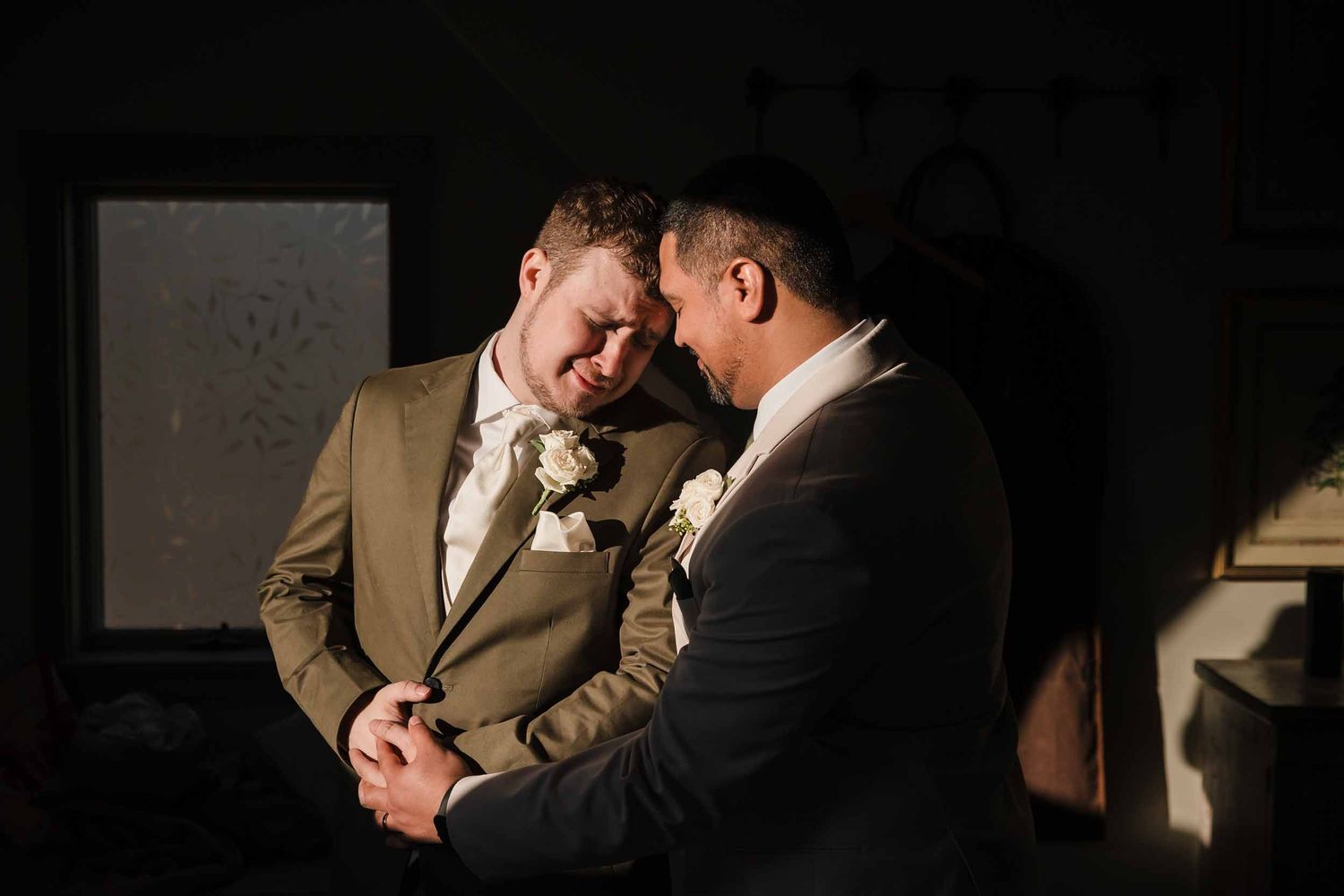 Couple sharing an emotional quiet moment together during wedding ceremony with dramatic lighting at Briar Barn Inn