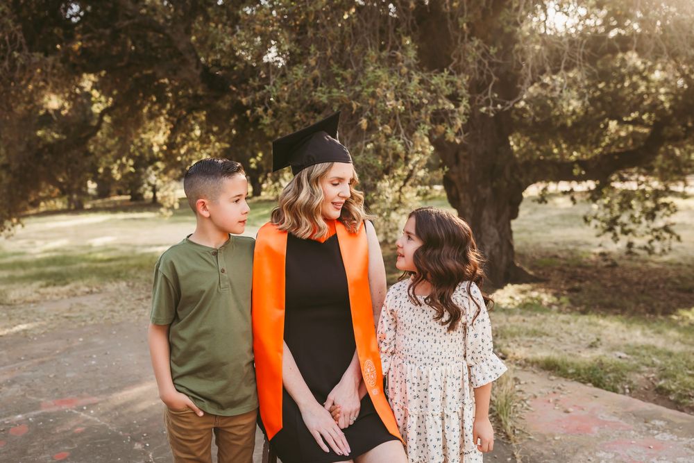 a mom and her two kids happy that mom is graduating nursing school with her masters in the inland empire