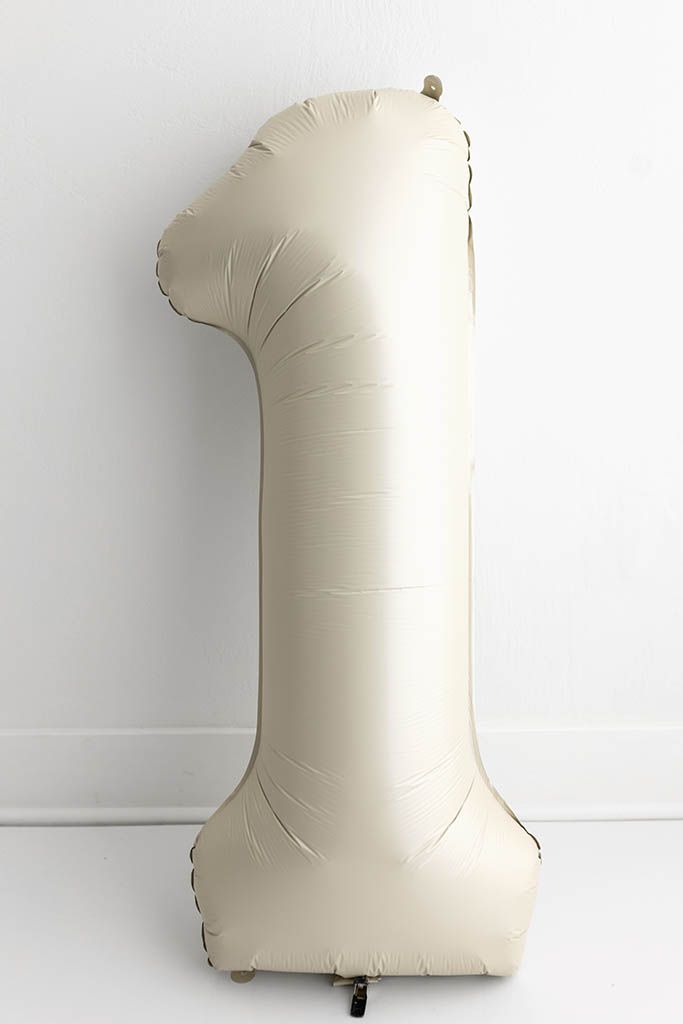 Cream matte foil number one balloon; Capturing baby’s first year from newborn sessions to first birthday cake smashes.