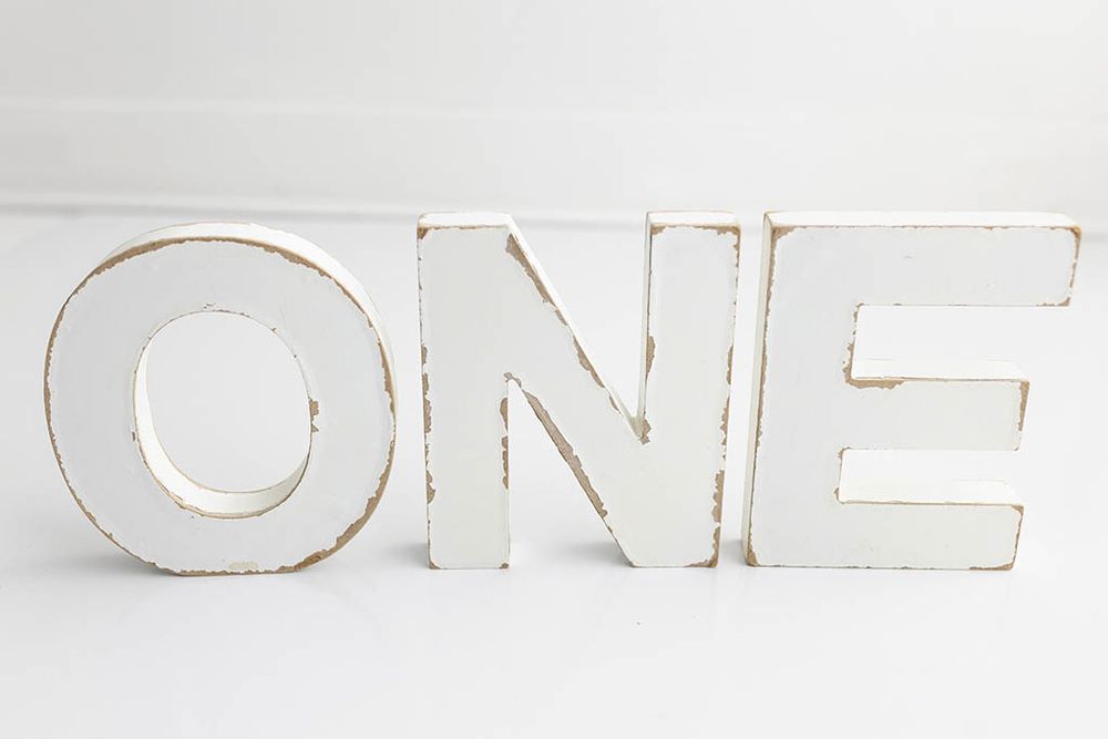 White distressed wooden ONE letter signs with rustic vintage finish for first birthday photo session; Baby Photographer in Lake Elsinore.
