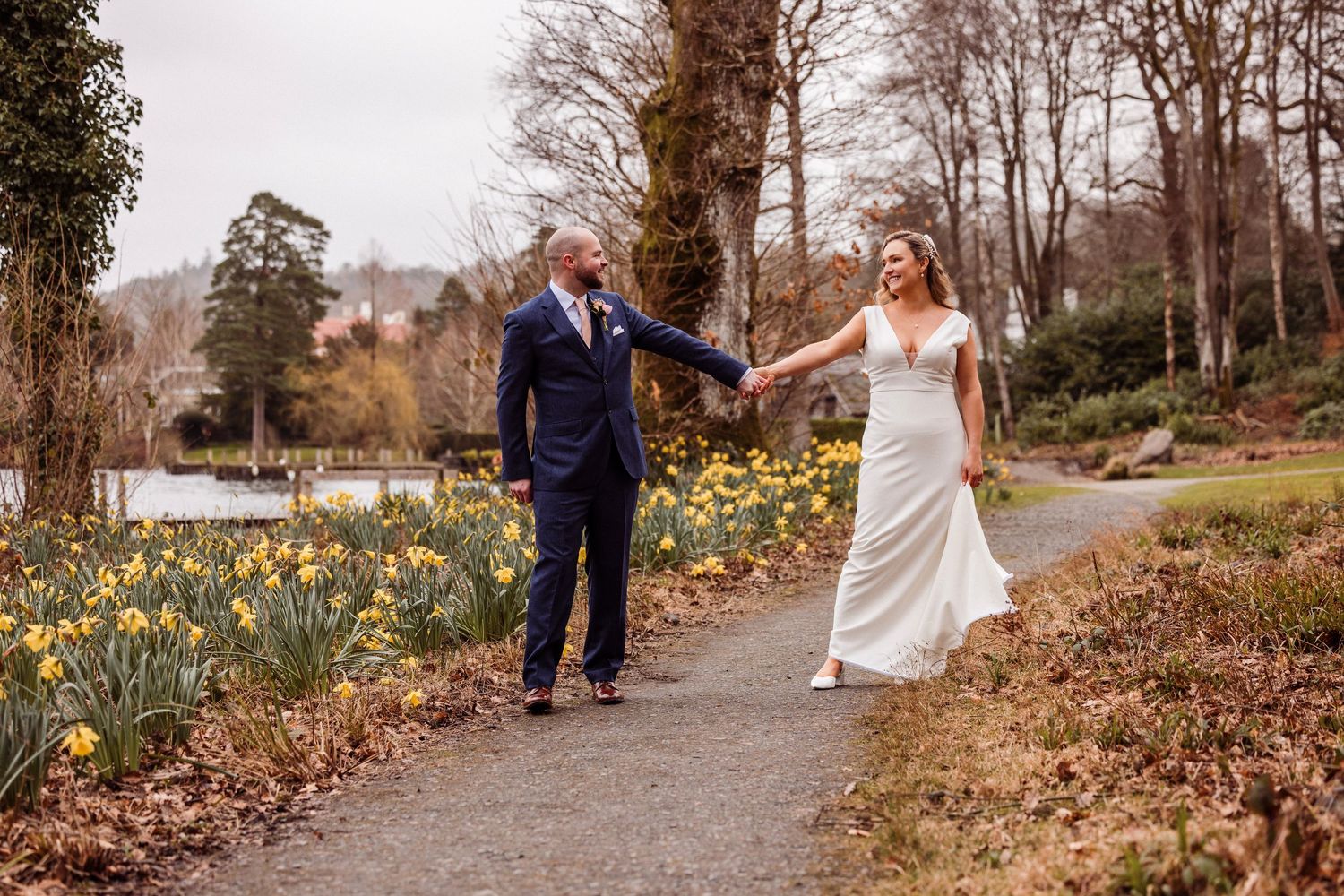 Couple walking through daffodils at Storrs Hall