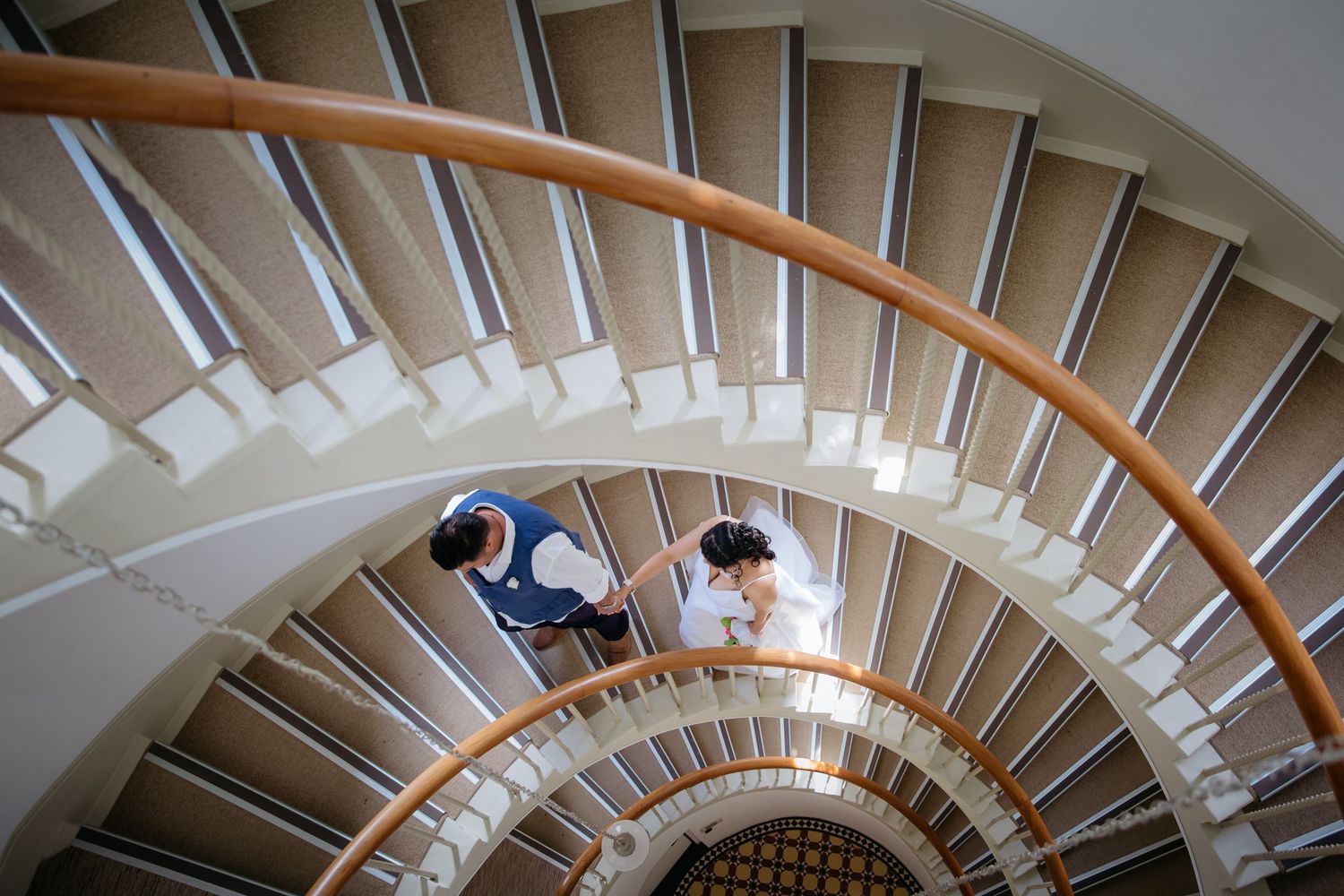 Artistic wedding photographer in Auckland capturing a bride and groom on a stair well