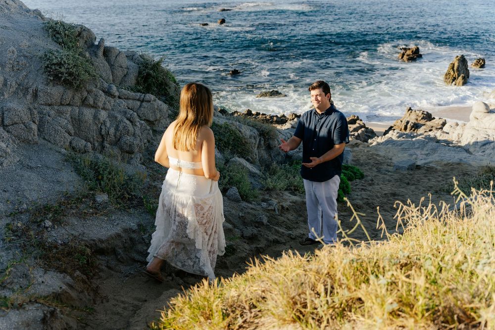 Couple exchanging vows on rocky coastal cliffs overlooking the ocean during a romantic outdoor elopement ceremony.