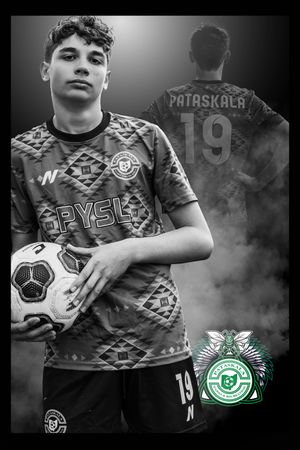Soccer player in geometric patterned jersey number 19 poses with ball against misty dark background.