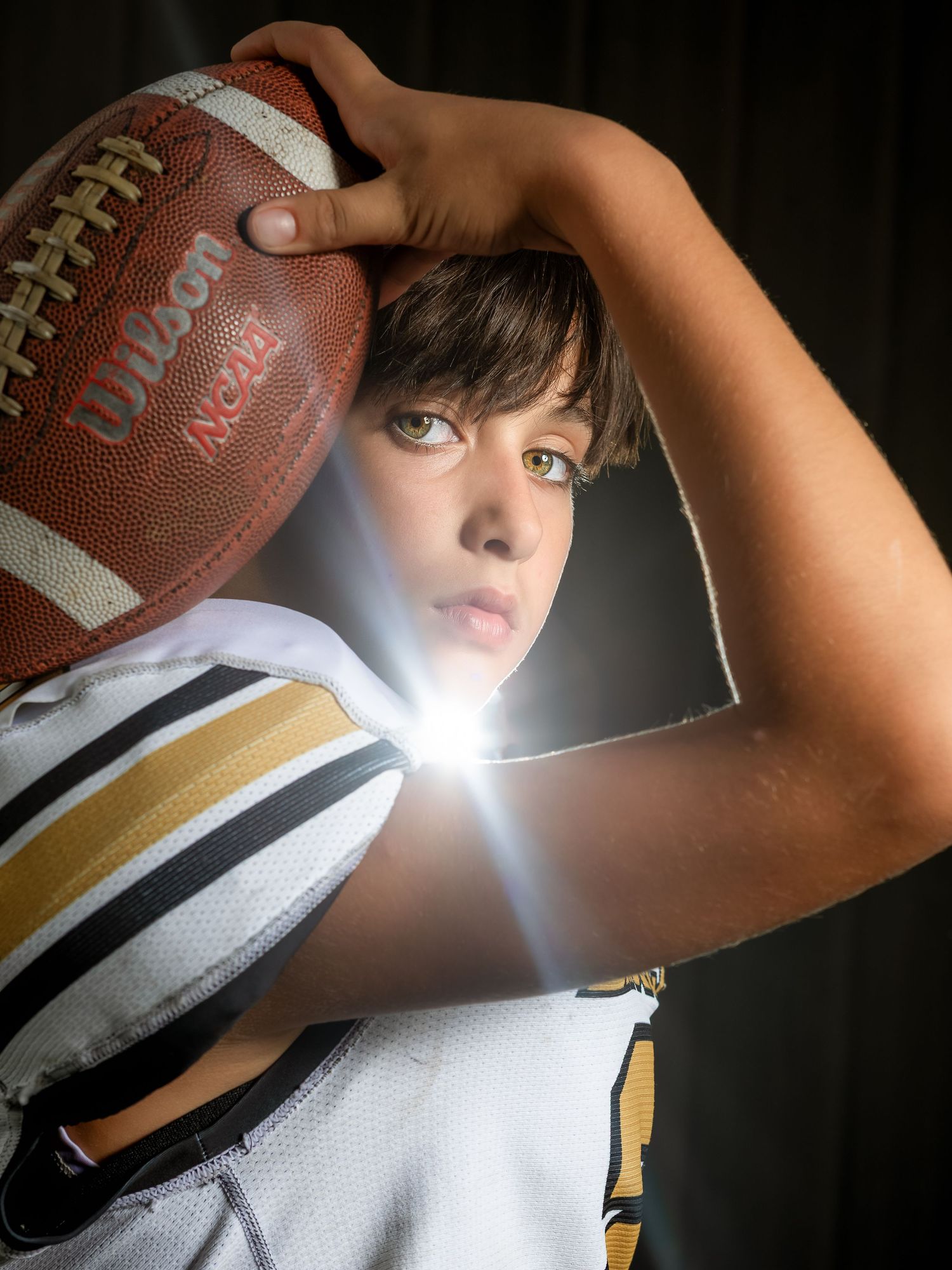 Dramatic high school football sportrait with sun flare in Lincoln, Alabama