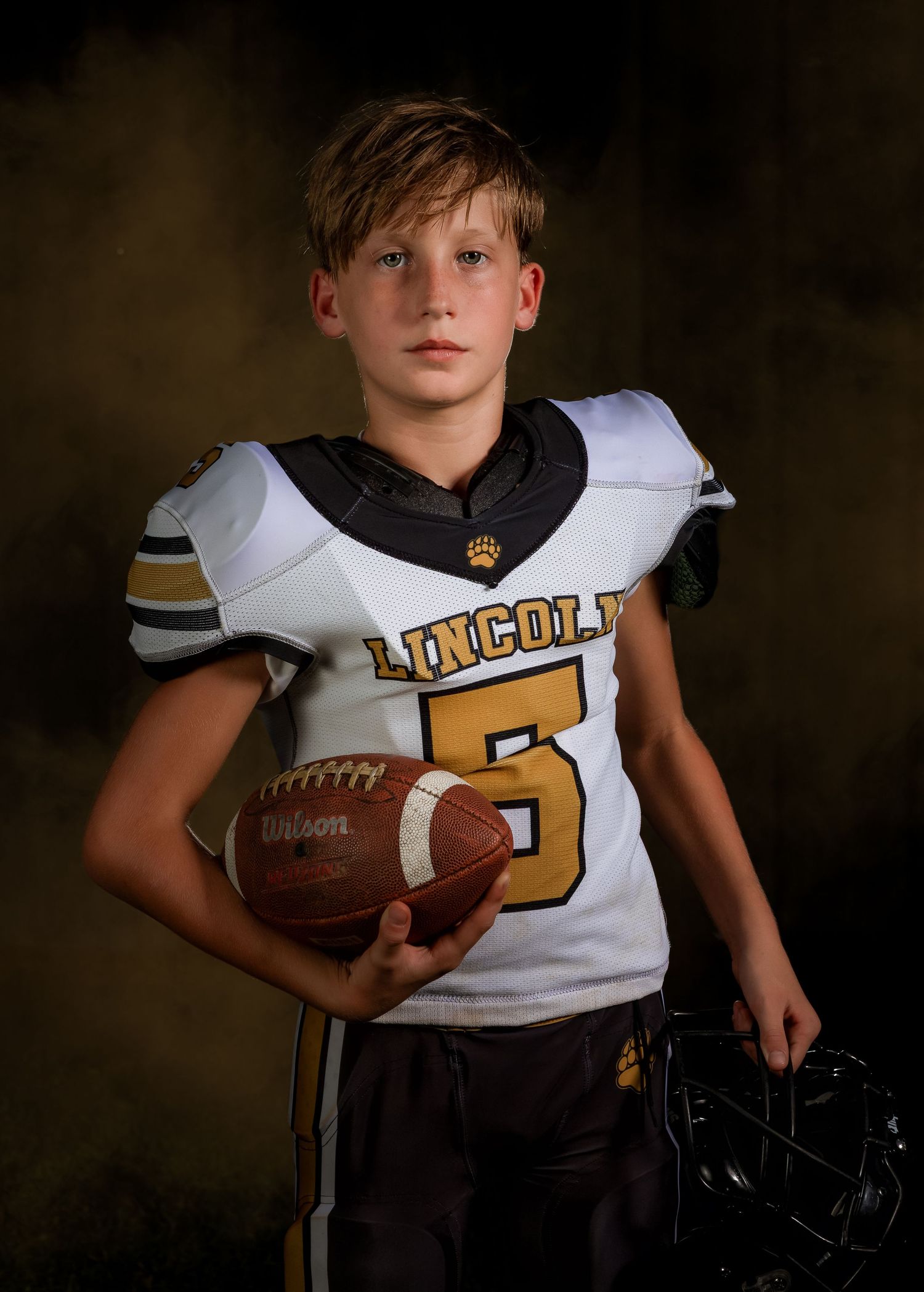 Lincoln, Alabama youth sportrait of a high school football player in full uniform.