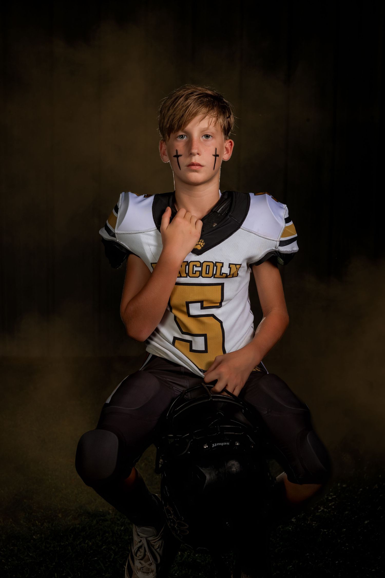 Lincoln, Alabama youth sportrait of a high school football player in full uniform.