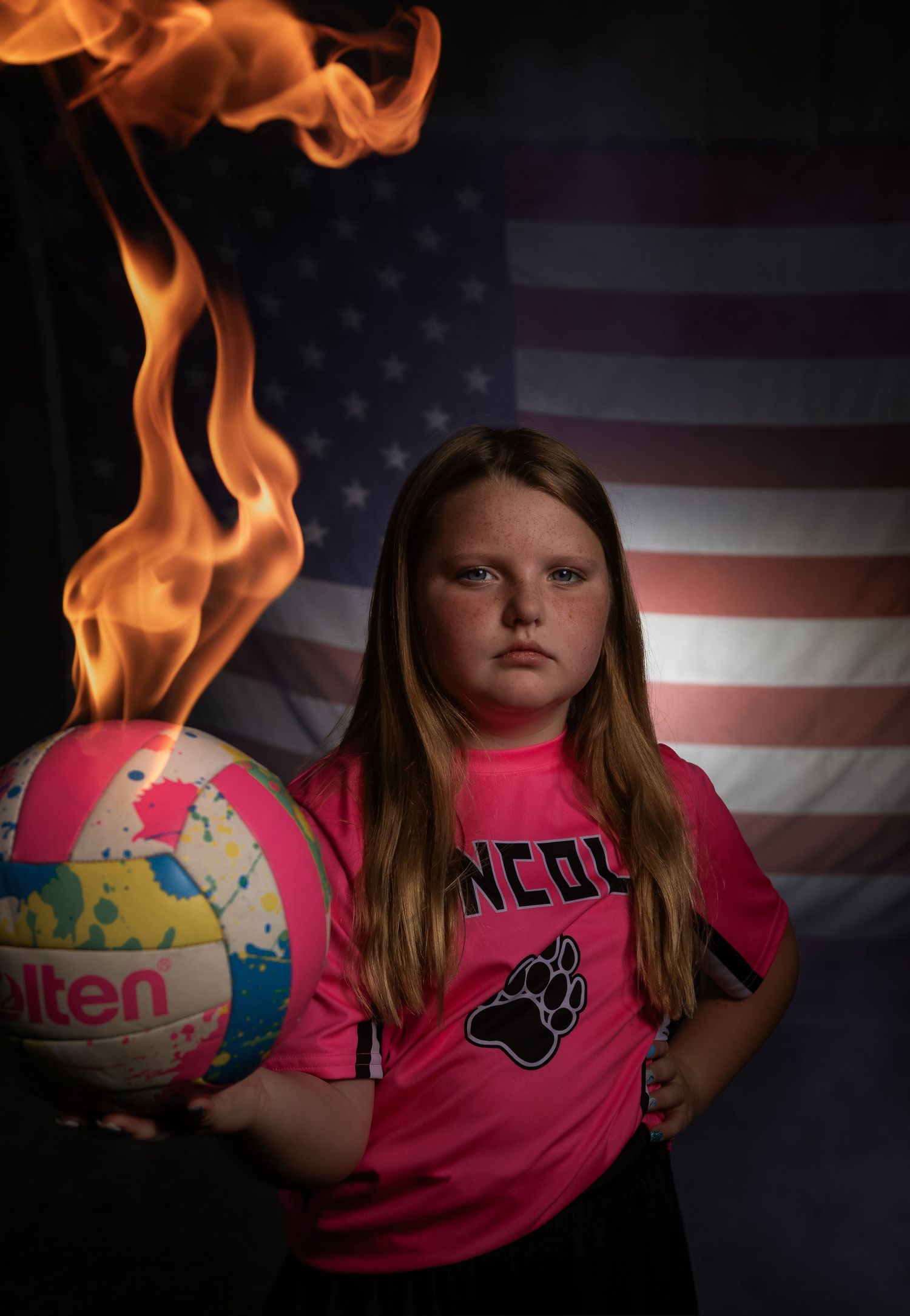 Creative youth volleyball sportrait featuring fire effects and American flag in Lincoln, Alabama.