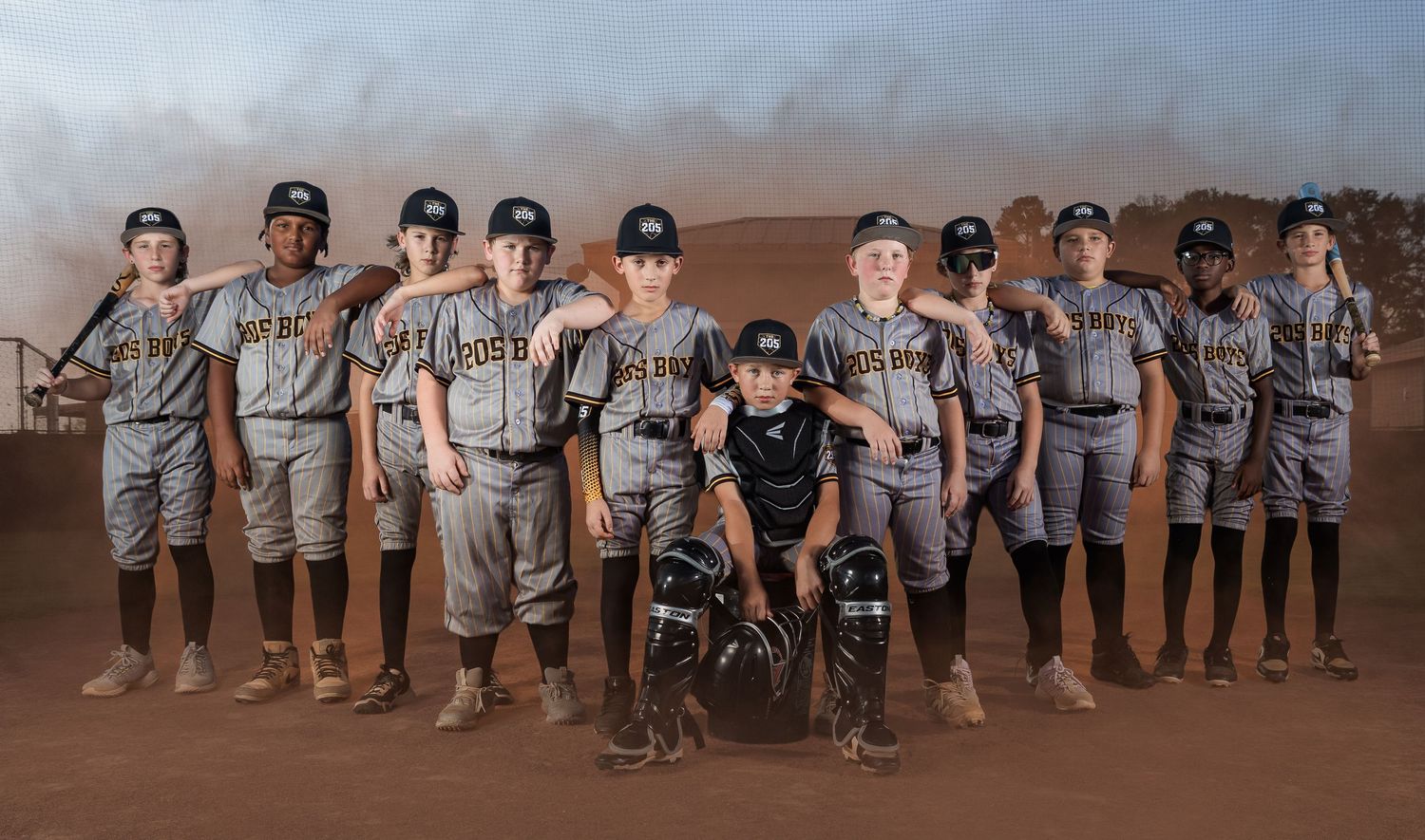 Youth baseball team portrait with dramatic smoke effects captured by Lincoln, Alabama sports photographer.