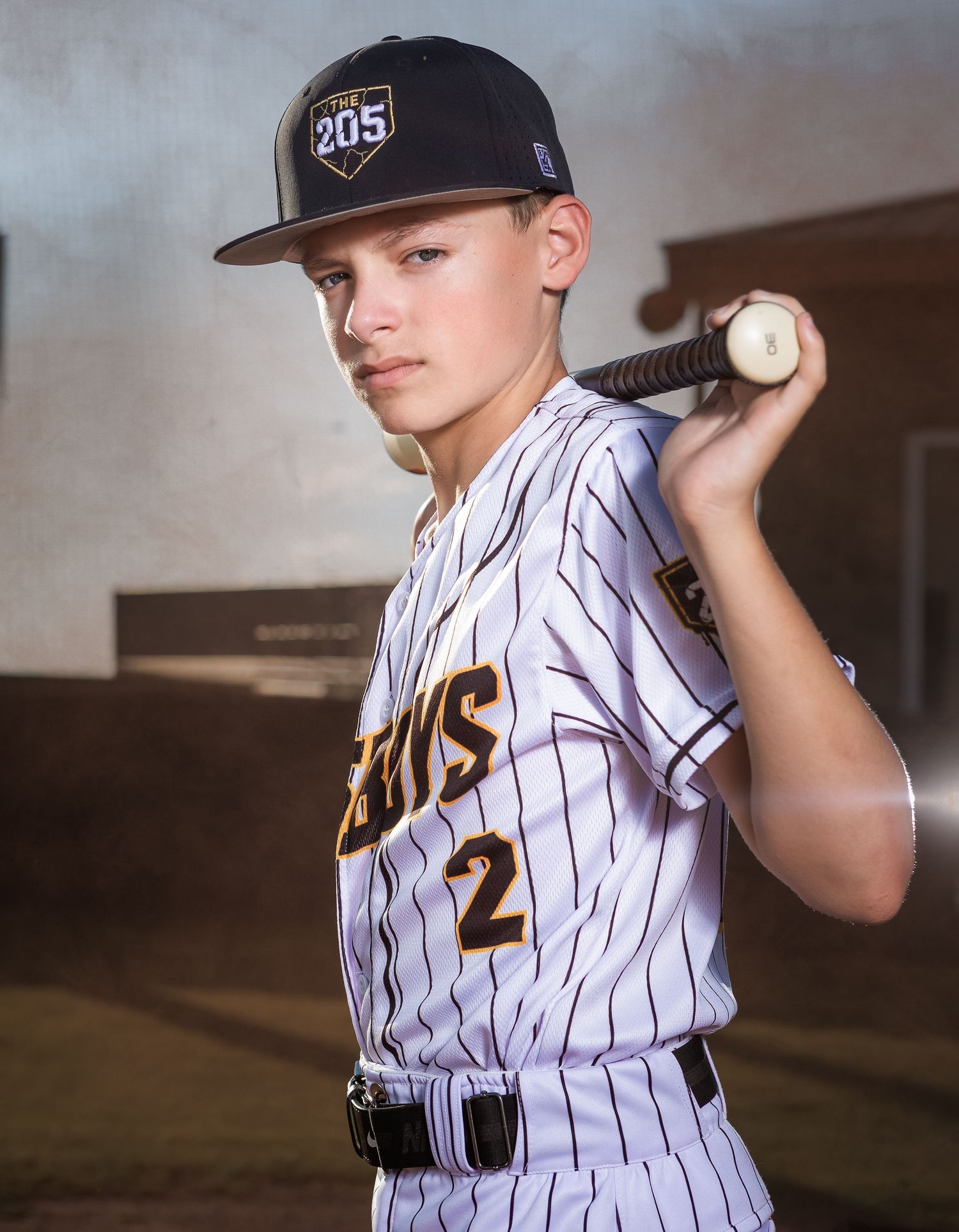 Professional youth baseball senior-style portrait at golden hour in Lincoln, Alabama.