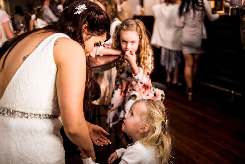 A tender moment shared during a wedding reception on a wooden dance floor.