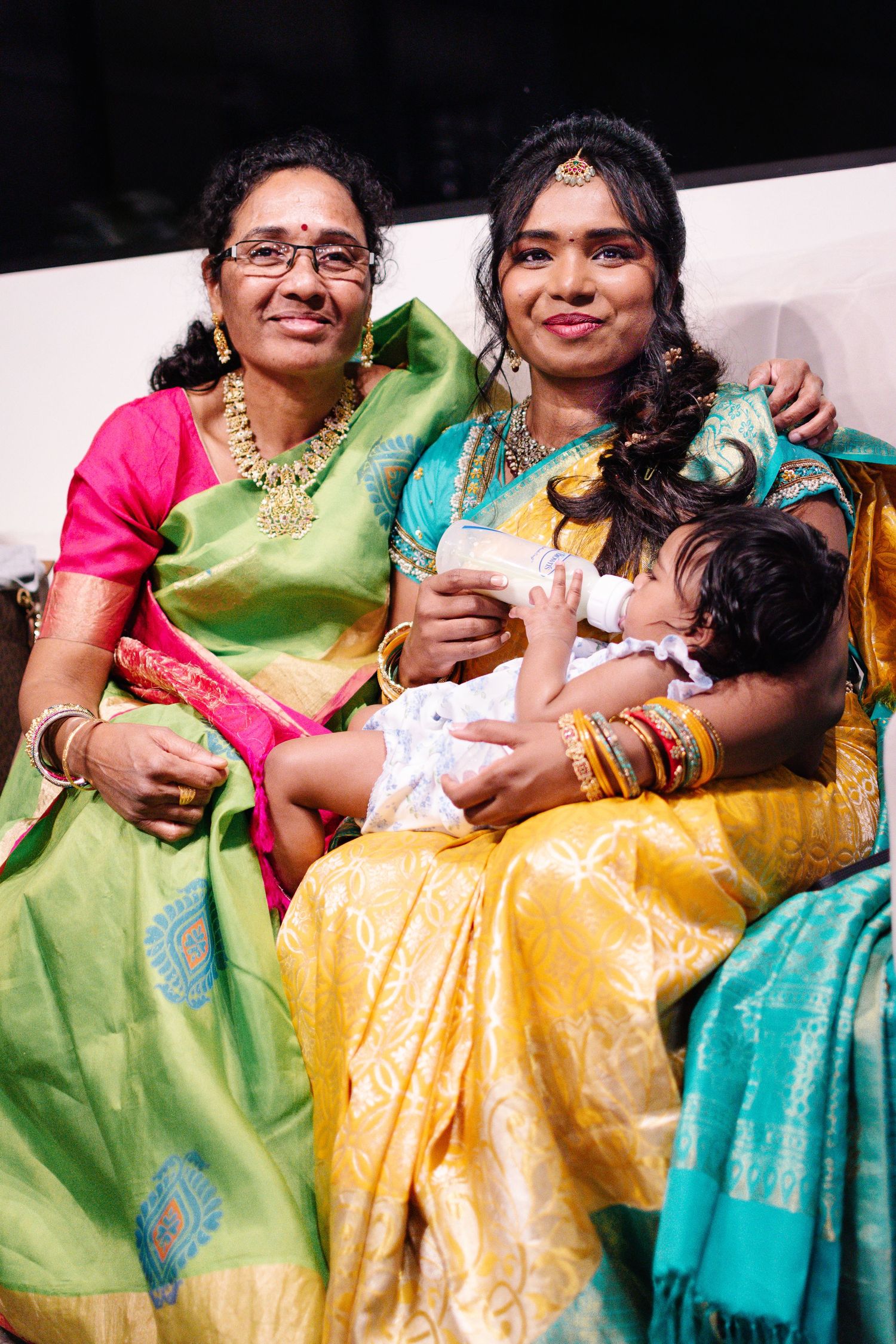 Three generations in colorful Indian attire celebrating Annaprashana—cultural family photography in Seattle.