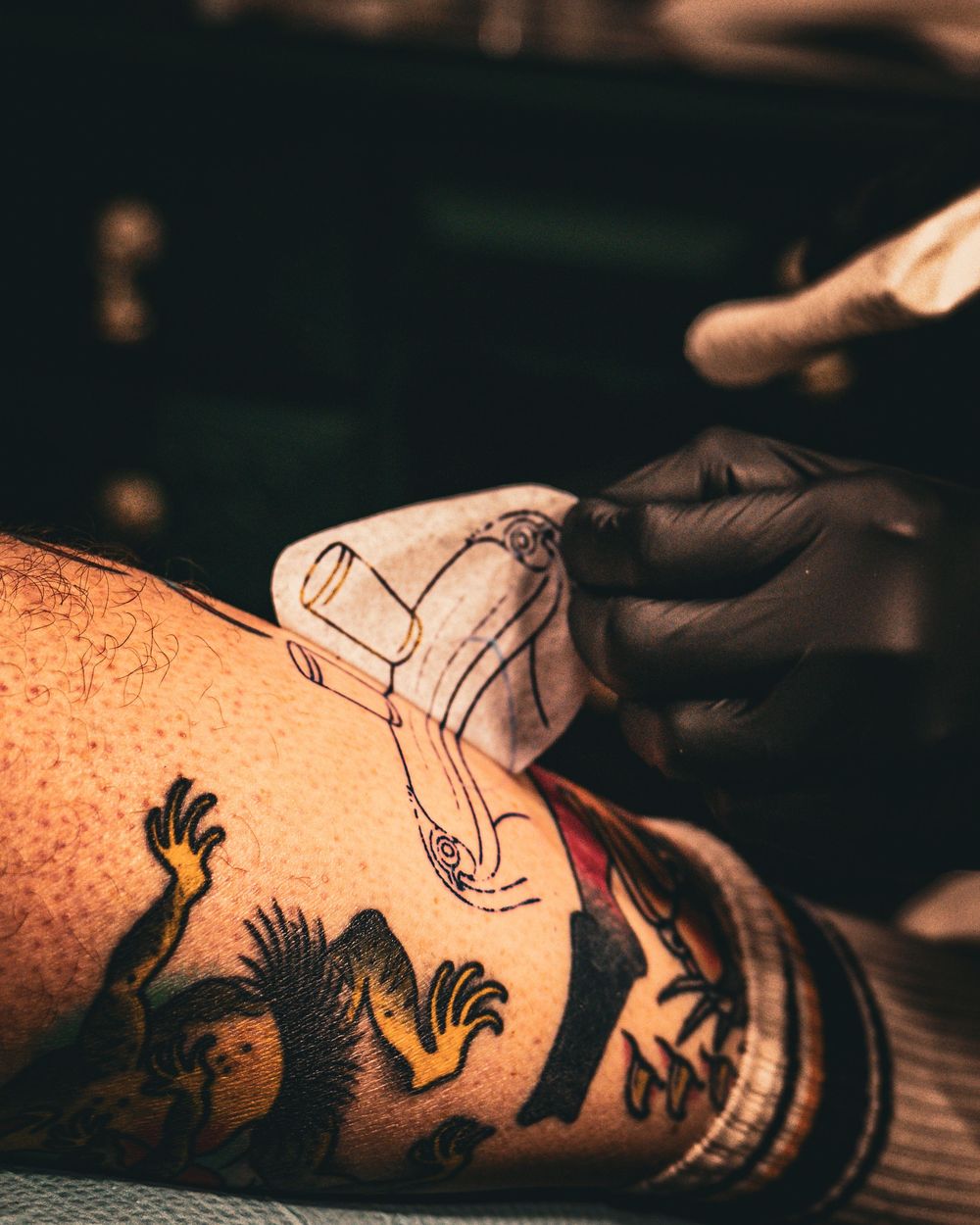Detailed view of tattoo art on skin during tattooing process.