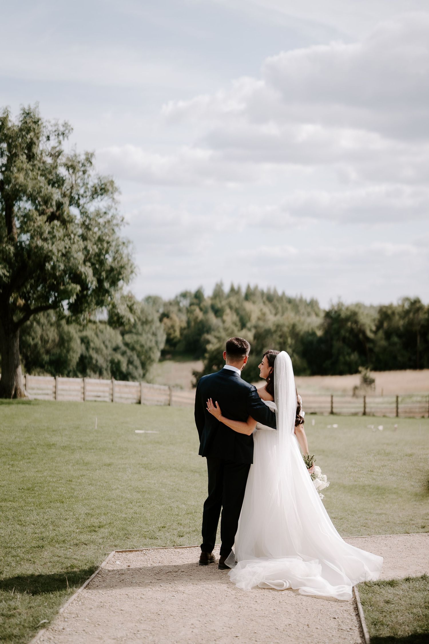 bride and groom looking out at view at yardspace old gore in cirencester